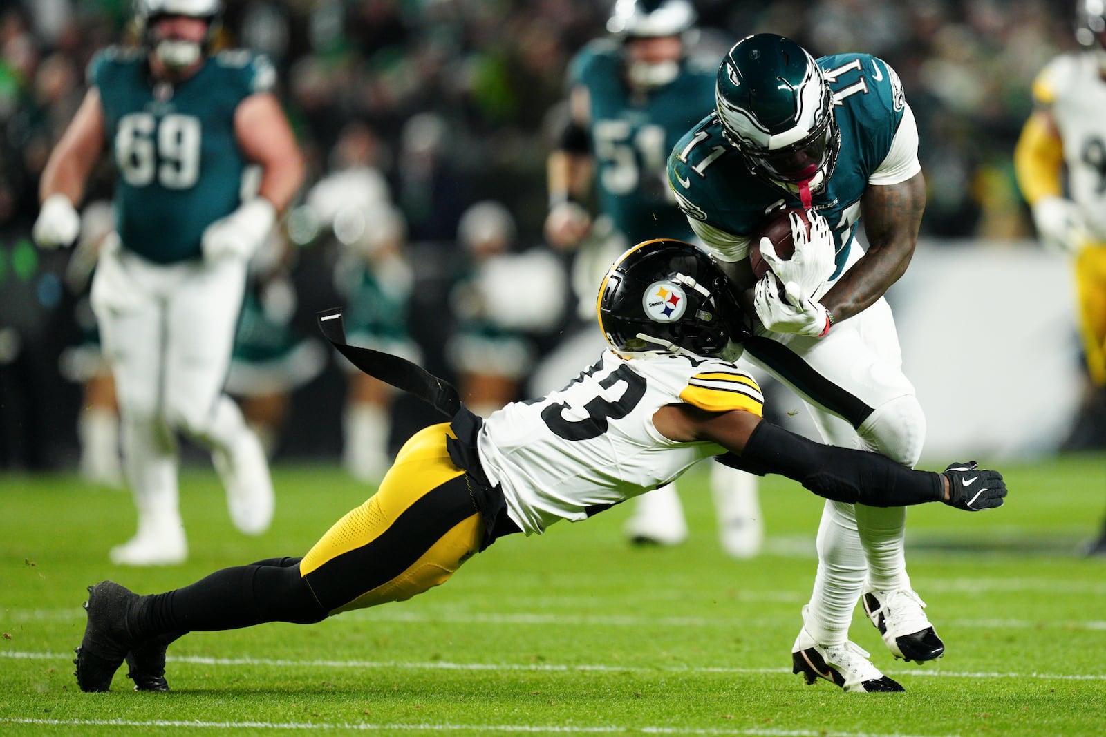 Philadelphia Eagles wide receiver A.J. Brown (11) is tackled by Pittsburgh Steelers safety Damontae Kazee (23) during the first half of an NFL football game Sunday, Dec. 15, 2024, in Philadelphia. (AP Photo/Derik Hamilton)