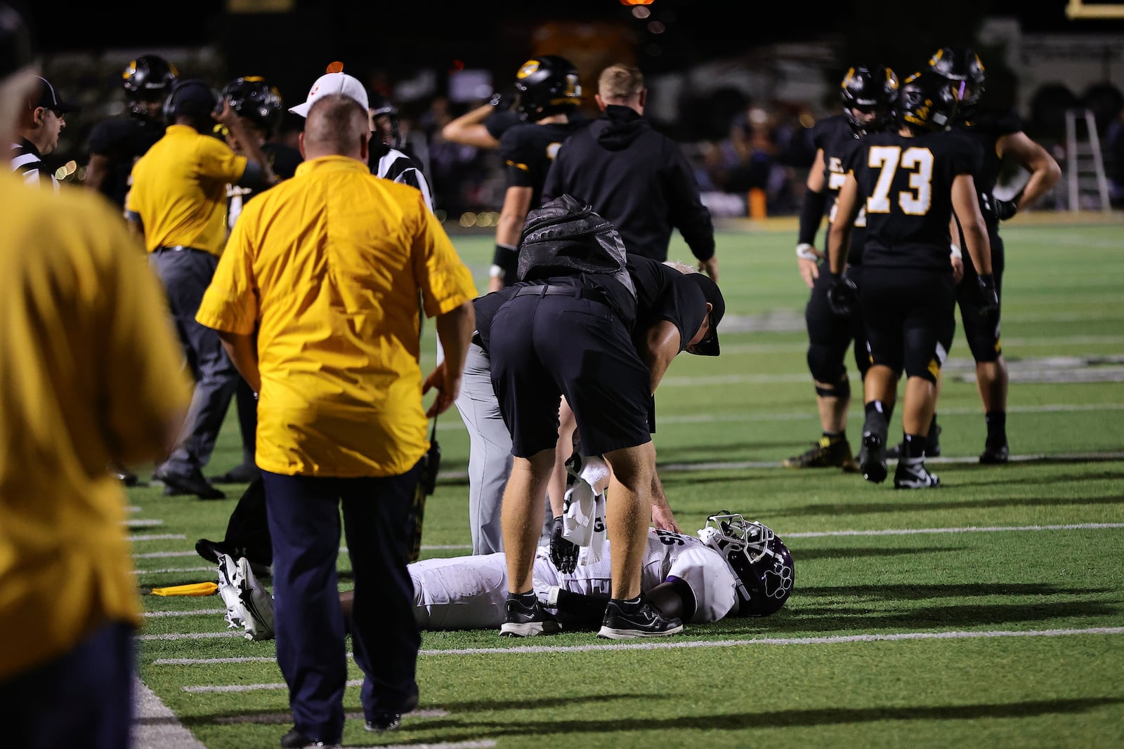 Centerville High School athletic trainer Brandon Craig checks on a Pickerington Central football player who was shaken up during the schools' game Sept. 1, 2023. Contributed Photo / Barry Burtenshaw