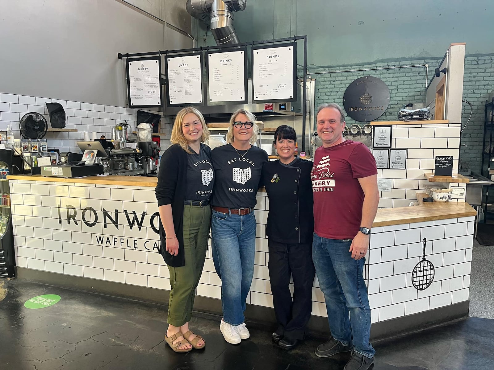 Springfield entrepreneurs, Lisa and Dan Freeman, who own Le Torte Dolci Bakery, Salato Deli and Crust & Company are creating an “umbrella brand” for their businesses as they announce the purchase of Ironworks Waffle Café. Pictured left to right are Ellie and Marcy Nesselroade and Lisa and Dan Freeman (Facebook Photo).