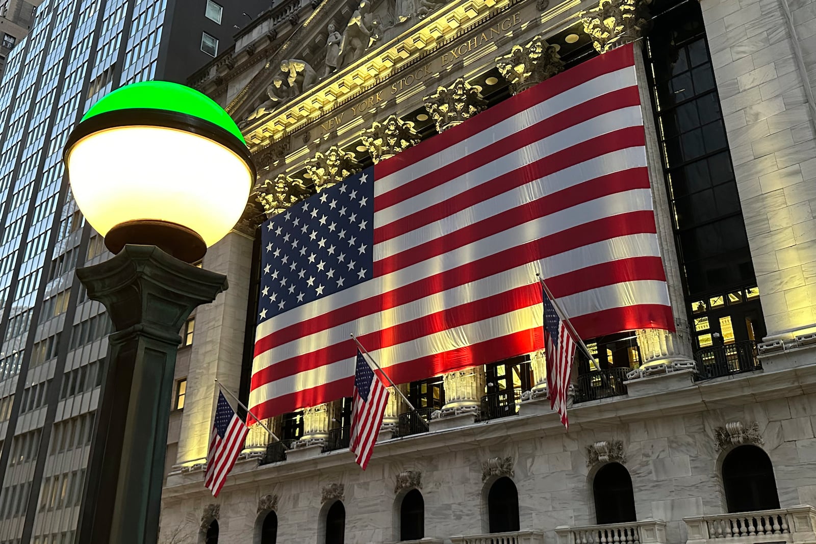 FILE - The American flags hangs on the facade of the New York Stock Exchange in New York's Financial District on Tuesday, Nov. 5, 2024. (AP Photo/Peter Morgan, File)