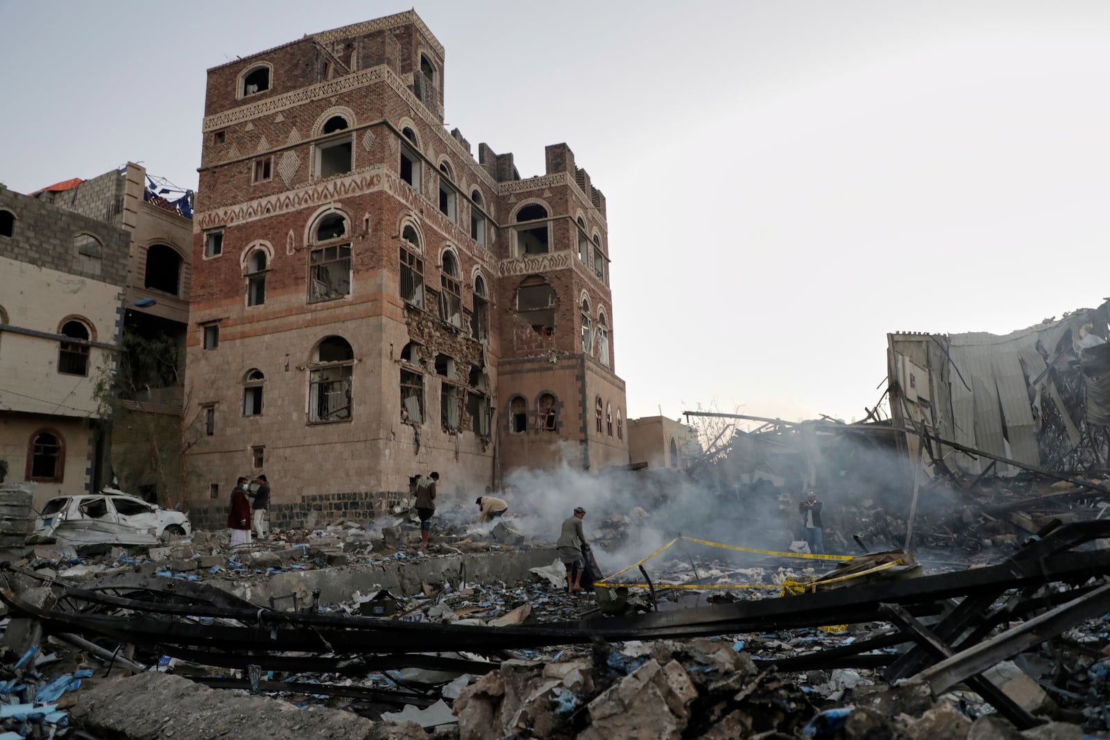 Locals inspect the site reportedly struck by U.S. airstrikes overnight in Sanaa, Yemen, Thursday, March 20, 2025. (AP Photo)