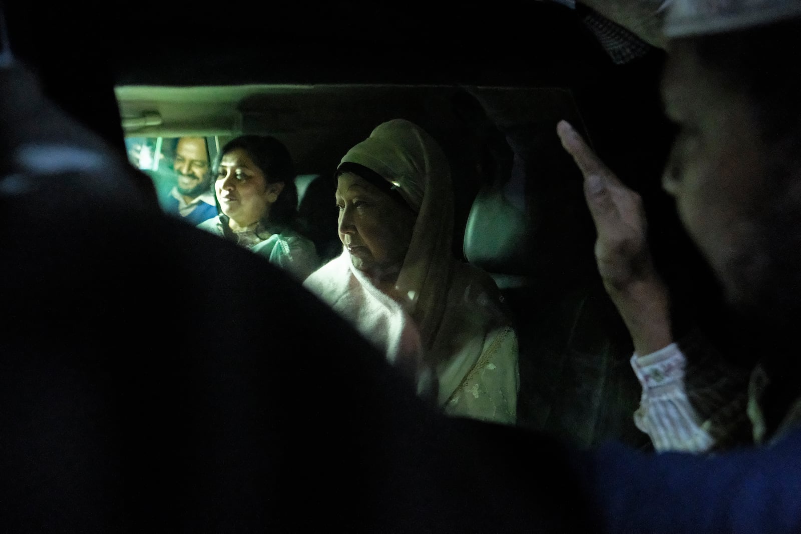 Bangladesh's ailing former Prime Minister Khaleda Zia, right, leaves in a car on her way to the airport in Dhaka, Bangladesh, to travel to London for medical treatment, Tuesday, Jan. 7, 2025. (AP Photo/Mahmud Hossain Opu)