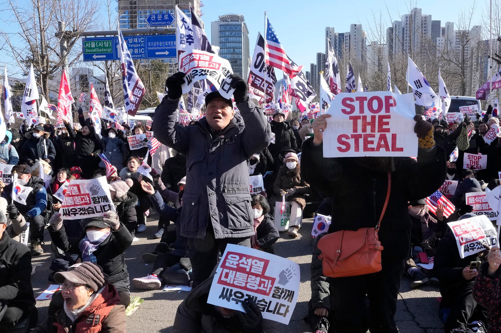 Supporters of impeached South Korean President Yoon Suk Yeol stage a rally to oppose his impeachment near the Corruption Investigation Office for High-ranking Officials in Gwacheon, South Korea, Wednesday, Jan. 15, 2025. The signs read "We will fight together with President Yoon Suk Yeol." (AP Photo/Ahn Young-joon)