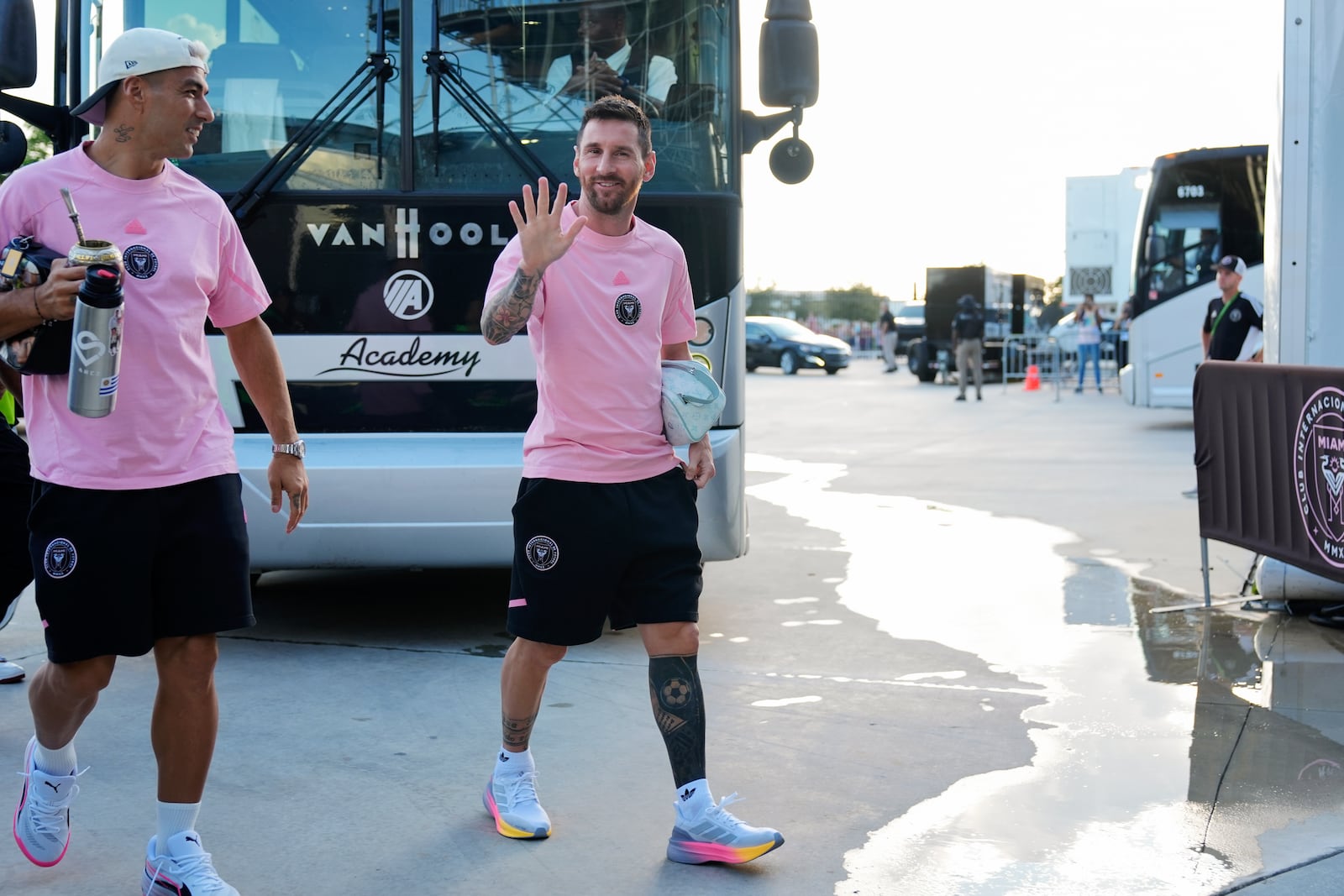 Inter Miami forward Lionel Messi, right, waves as he arrives with forward Luis Suarez, left, for an MLS soccer match against Charlotte FC, Saturday, Sept. 28, 2024, in Fort Lauderdale, Fla. (AP Photo/Rebecca Blackwell)