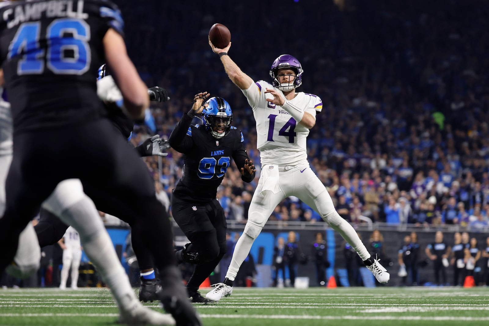 Minnesota Vikings quarterback Sam Darnold (14) throws against the Detroit Lions during the first half of an NFL football game Sunday, Jan. 5, 2025, in Detroit. (AP Photo/Rey Del Rio)