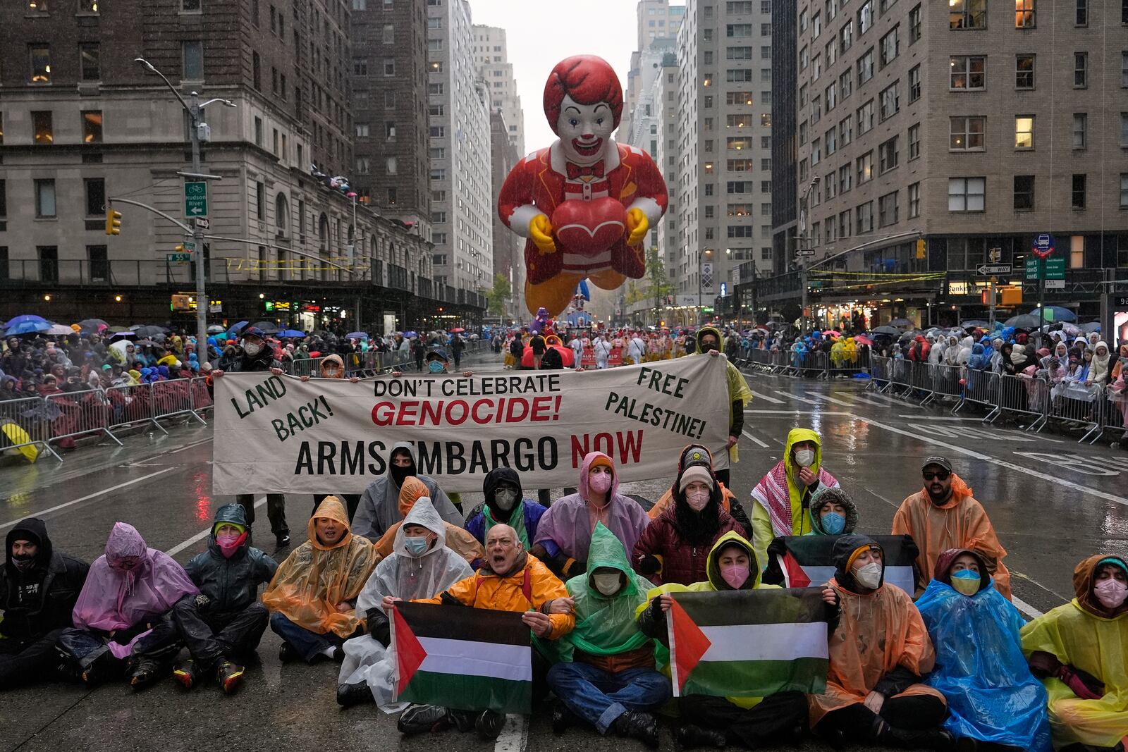 Pro-Palestinian protesters demonstrate on Sixth Avenue during the Macy's Thanksgiving Day Parade, Thursday, Nov. 28, 2024, in New York. (AP Photo/Julia Demaree Nikhinson)