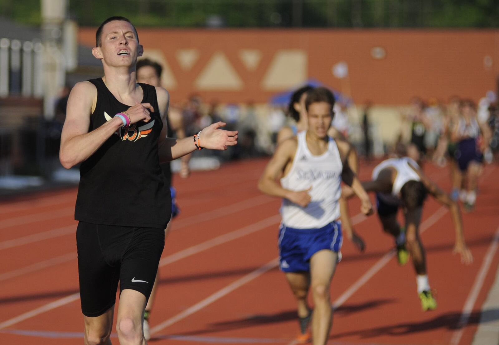 Beavercreek senior Riley Buchholz (left) won the 1,600 meters during the D-I regional track and field meet at Wayne High School on Friday, May 24, 2019. MARC PENDLETON / STAFF