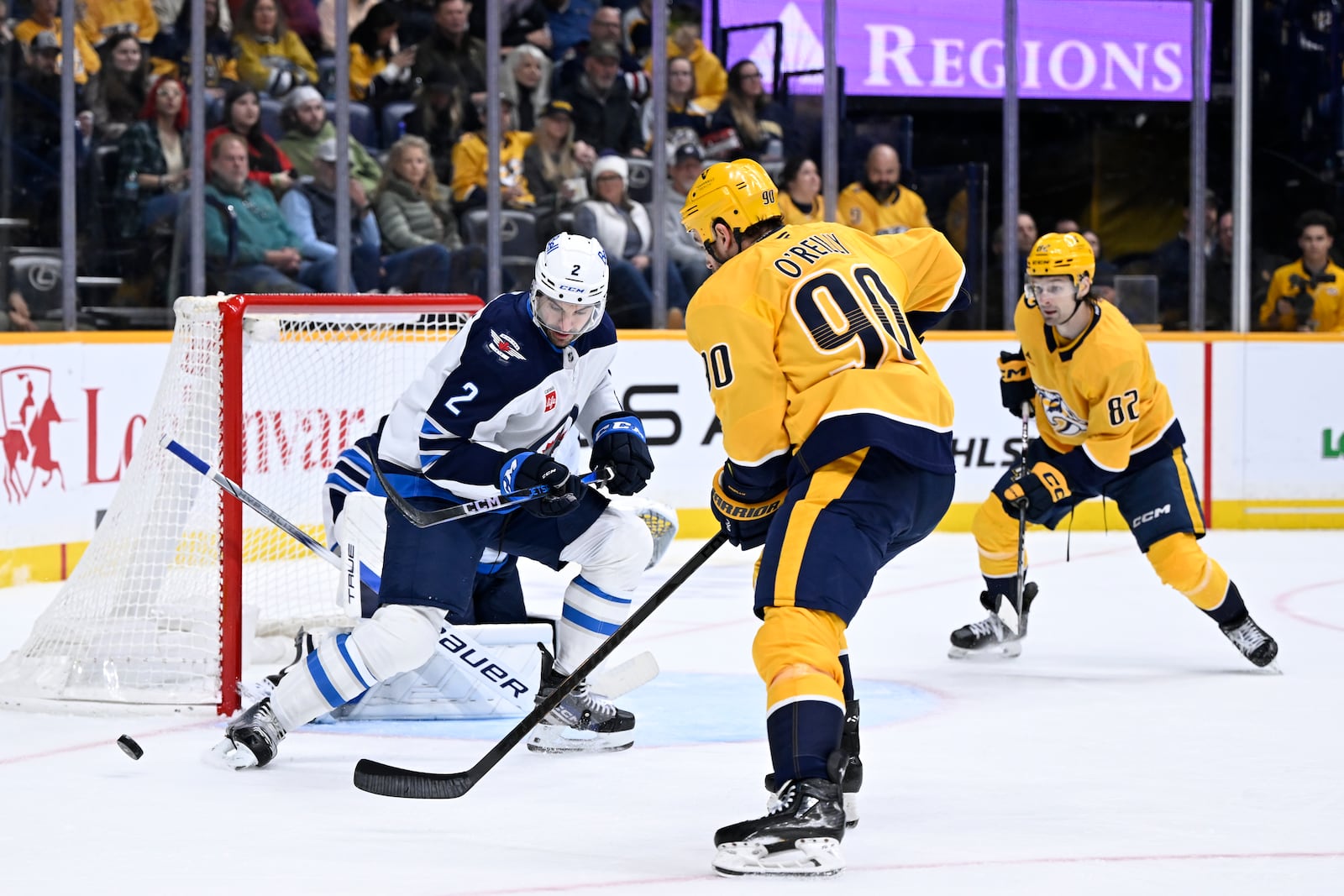 Nashville Predators center Ryan O'Reilly (90) shoots as Winnipeg Jets defenseman Dylan DeMelo (2) defends during the second period of an NHL hockey game Thursday, Feb. 27, 2025, in Nashville, Tenn. (AP Photo/John Amis)