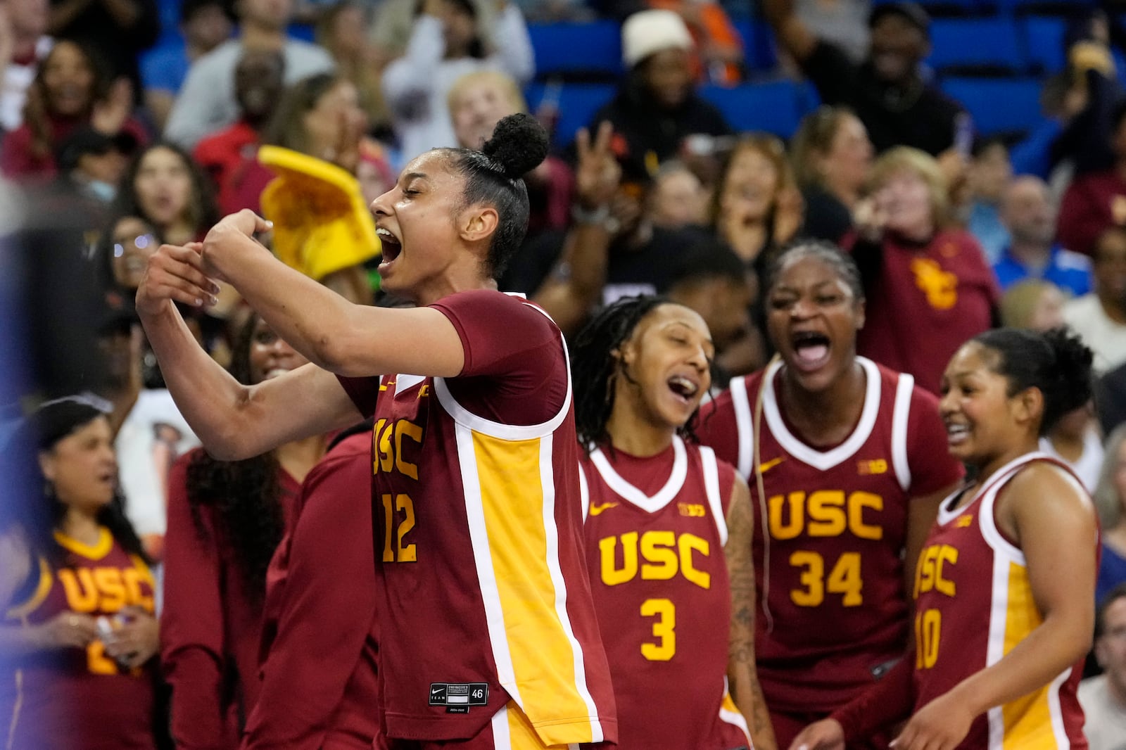 Southern California guard JuJu Watkins, left, celebrates with teammates during the second half of an NCAA college basketball game against UCLA Saturday, March 1, 2025, in Los Angeles. (AP Photo/Mark J. Terrill)