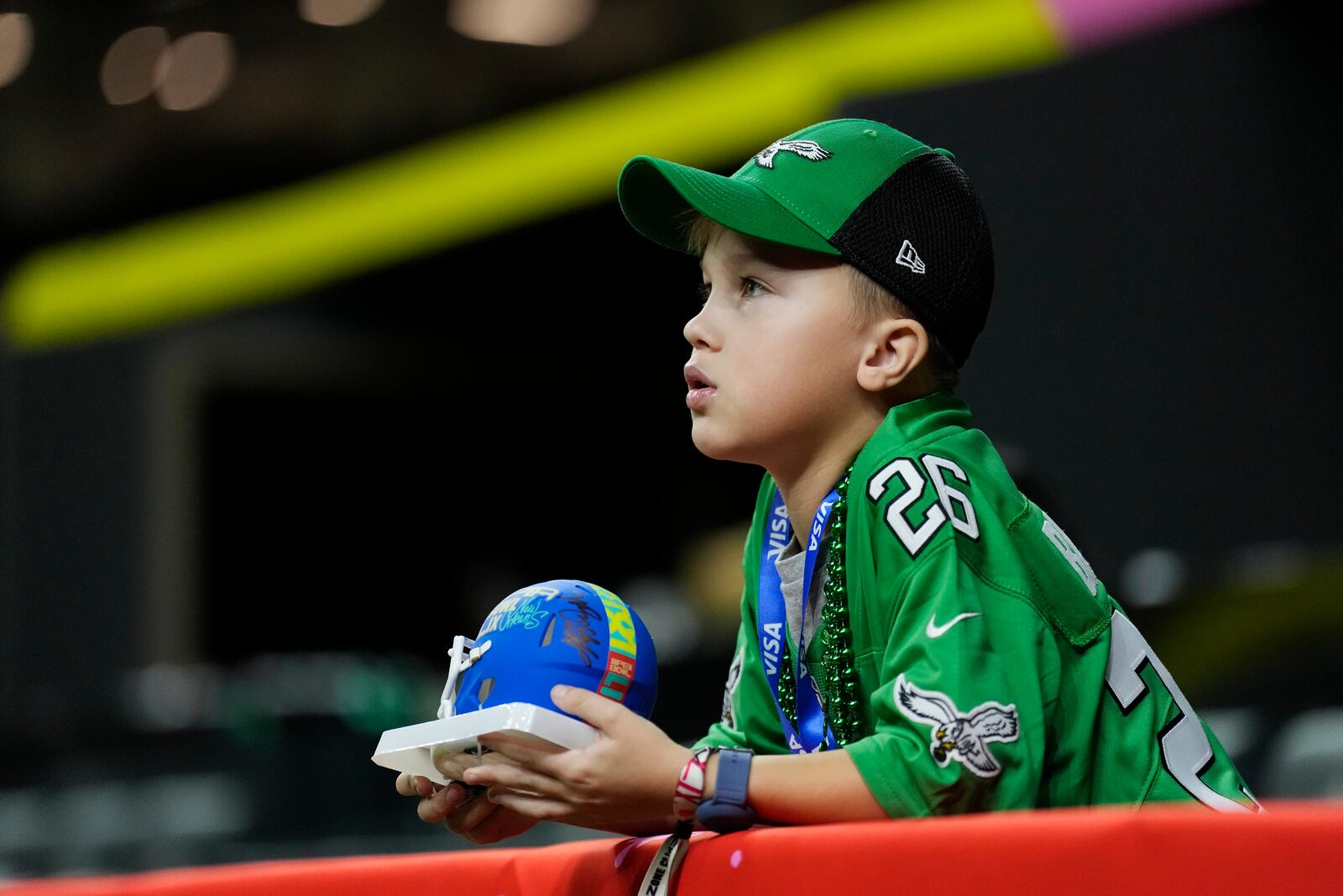 A young fan watches prior an NFL Super Bowl 59 football game between the Philadelphia Eagles and the Kansas City Chiefs, Sunday, Feb. 9, 2025, in New Orleans. (AP Photo/Ashley Landis)