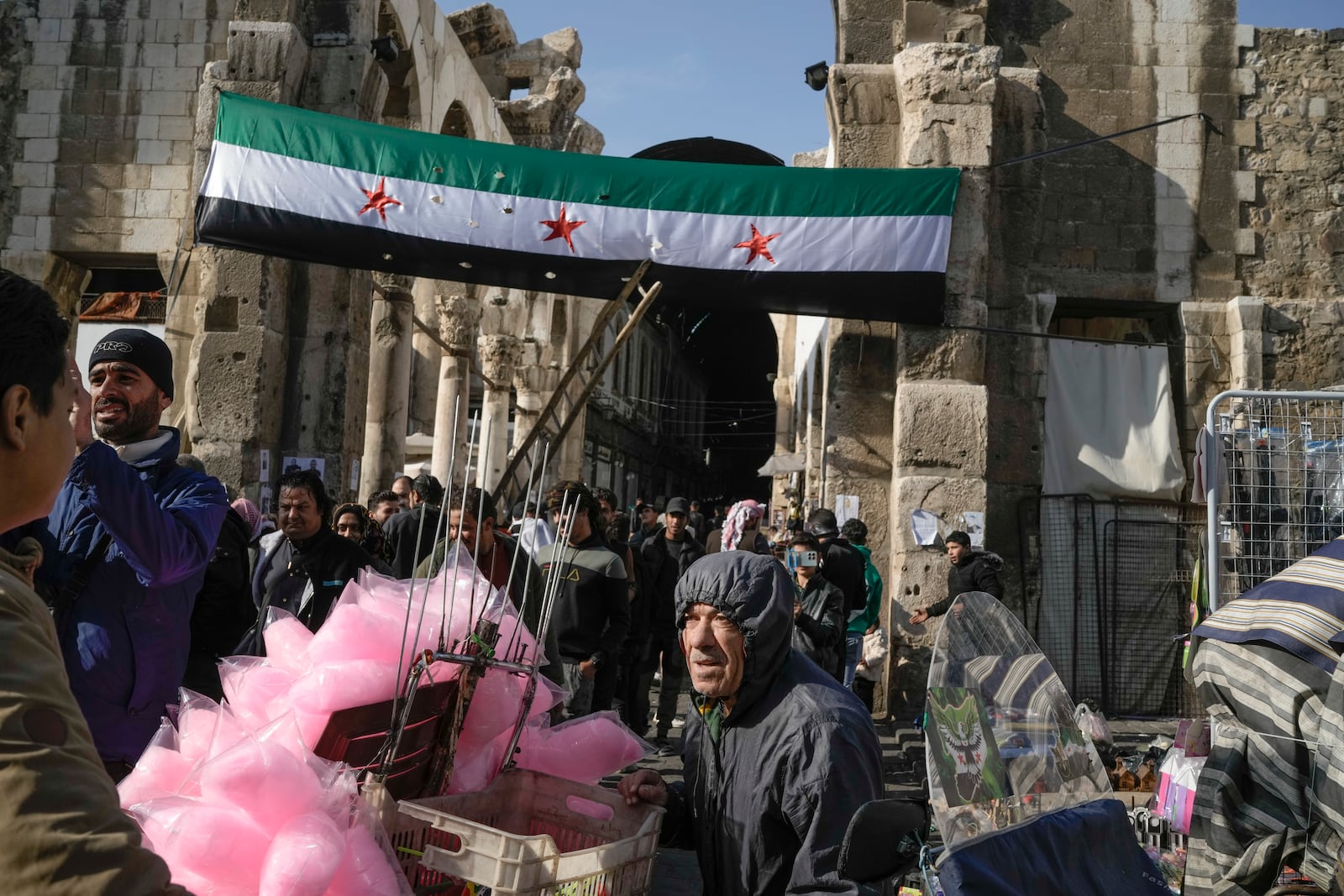 A Syrian "revolutionary" flag hangs at the entrance of the Umayyad Mosque ahead of Friday prayers in Damascus, Syria, Friday Dec. 20, 2024. 2024.(AP Photo/Leo Correa)