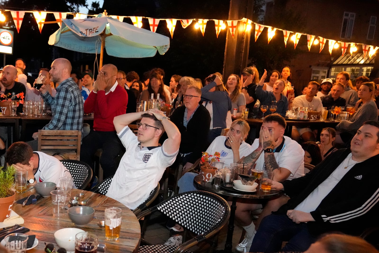 FILE - England fans react as they watch Spain win the Euro 2024 final match, at a pub in Wimbledon village, in London, July 14, 2024. The match is being played in Berlin. (AP Photo/Mark Baker, File)