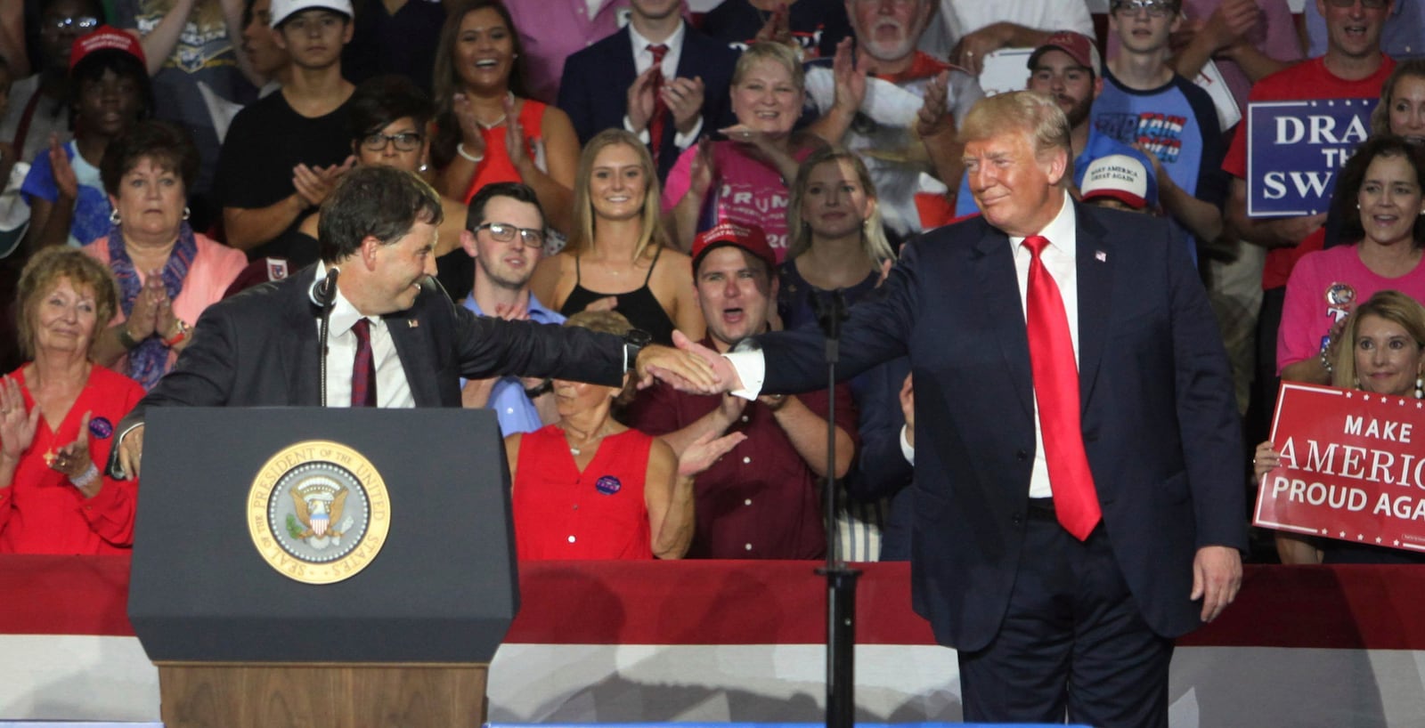 12th Congressional District Republican candidate Troy Balderson, left, shakes hands with President Donald Trump during a rally, Saturday, Aug. 4, 2018, in Lewis Center, Ohio.