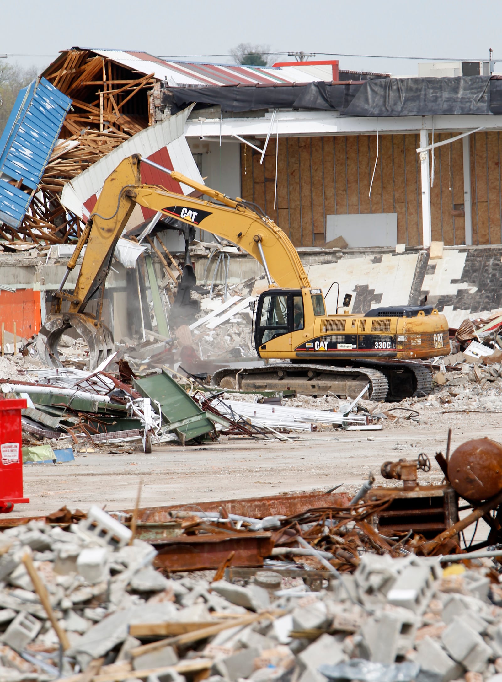 Demolition continues on Forest Park Plaza in Harrison Twp. Tuesday. The 50-acre site, at 4360 North Main St., will be open for redevelopment when the site is cleared by June. Regal Recycling, a demolition company, is tearing down the plaza at no cost for the value of the metal that can be salvaged and sold. LISA POWELL / STAFF