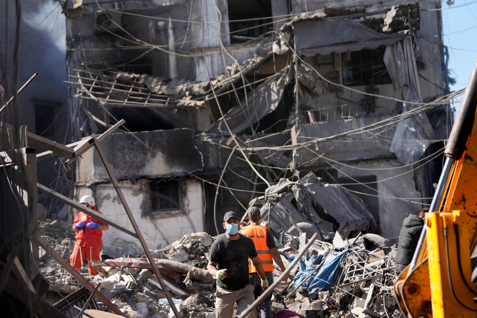 Rescue workers search for victims at the site of Israeli airstrikes that destroyed buildings facing the city's main government hospital in a densely-populated neighborhood, in southern Beirut, Lebanon, Tuesday, Oct. 22, 2024. (AP Photo/Hussein Malla)