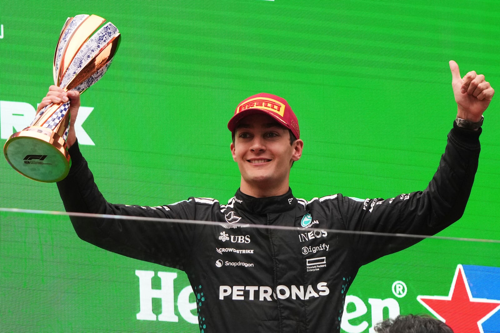 Mercedes driver George Russell of Britain celebrates on the podium after placing third in the Chinese Formula One Grand Prix race at the Shanghai International Circuit, Shanghai, Sunday, March 23, 2025. (AP Photo/Andy Wong)