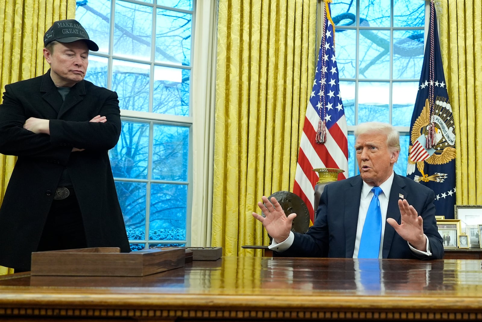 President Donald Trump speaks with reporters as Elon Musk listens in the Oval Office at the White House, Tuesday, Feb. 11, 2025, in Washington. (Photo/Alex Brandon)