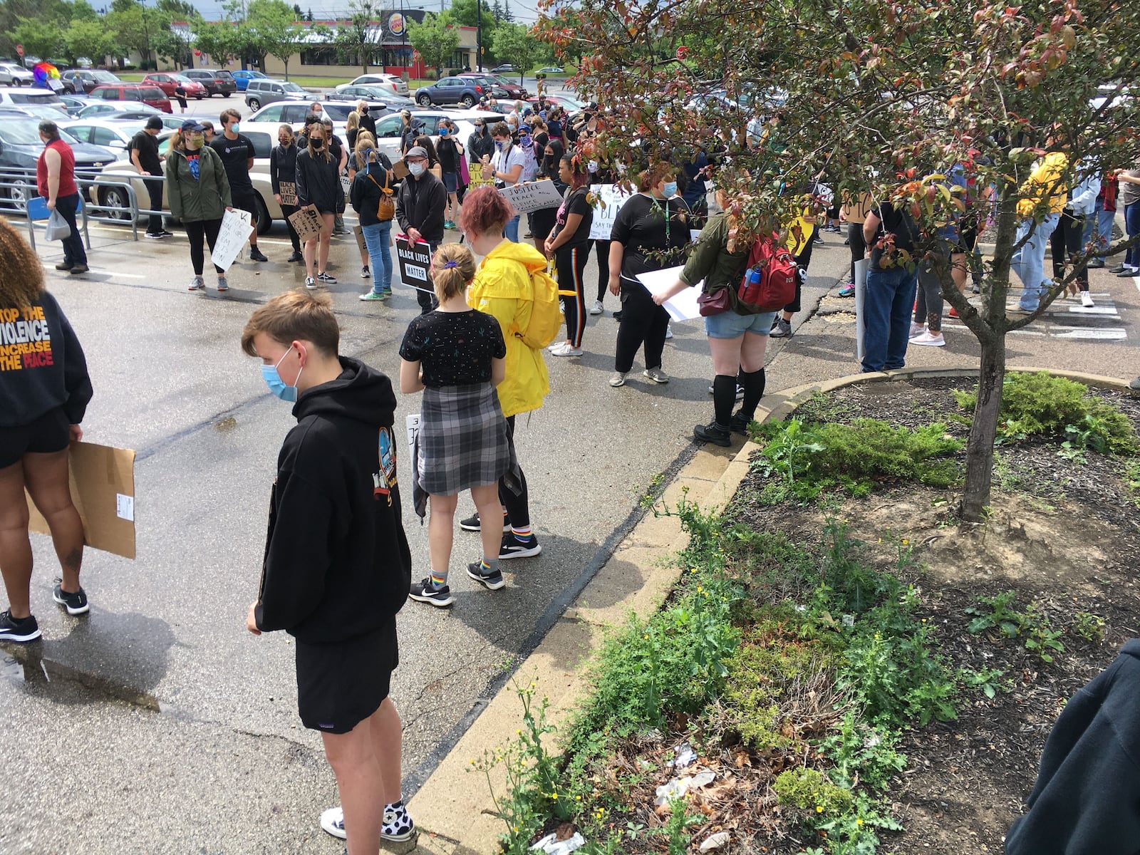 Nearly 40 demonstrators have gathered outside the Beavercreek Walmart to advocate for social justice. THOMAS GNAU/STAFF