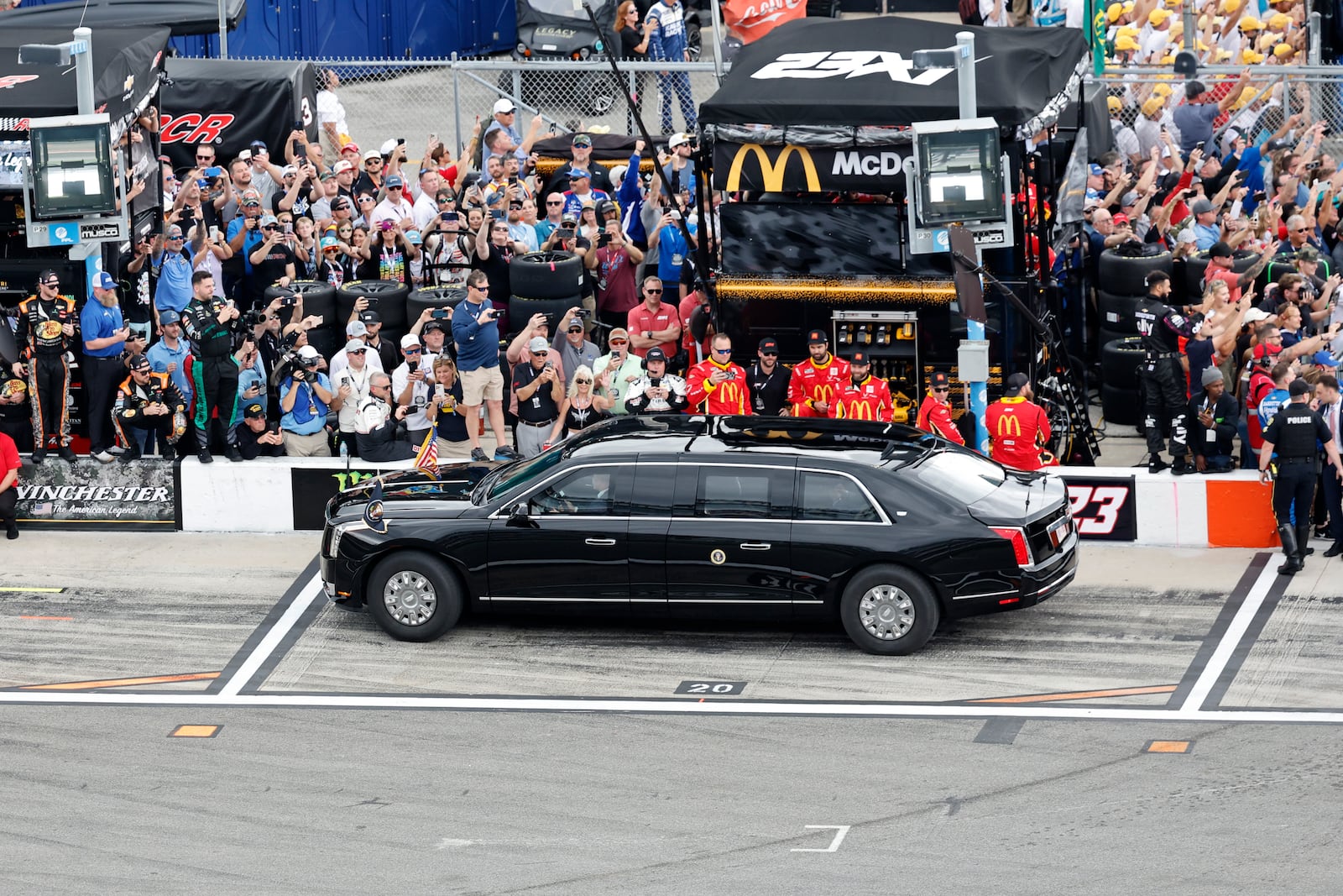 President Donald Trump rides in the presidential limousine known as "The Beast," as he drives to take a pace lap ahead of the start of the NASCAR Daytona 500 auto race at Daytona International Speedway, Sunday, Feb. 16, 2025, in Daytona Beach, Fla. (AP Photo/David Graham)