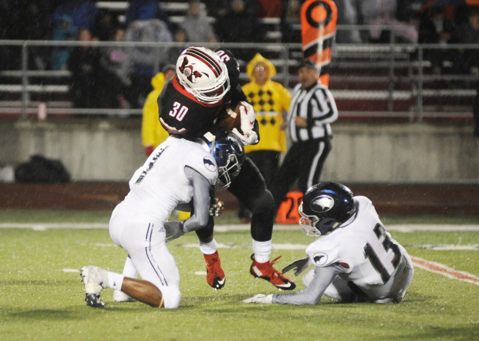 Wayne’s Devin Nelson (30) is taken down by Fairmont’s Marqies Williams (left) and Andrew Murray. Wayne defeated visiting Fairmont 49-44 in a Week 8 high school football game on Friday, oct. 12, 2018. MARC PENDLETON / STAFF