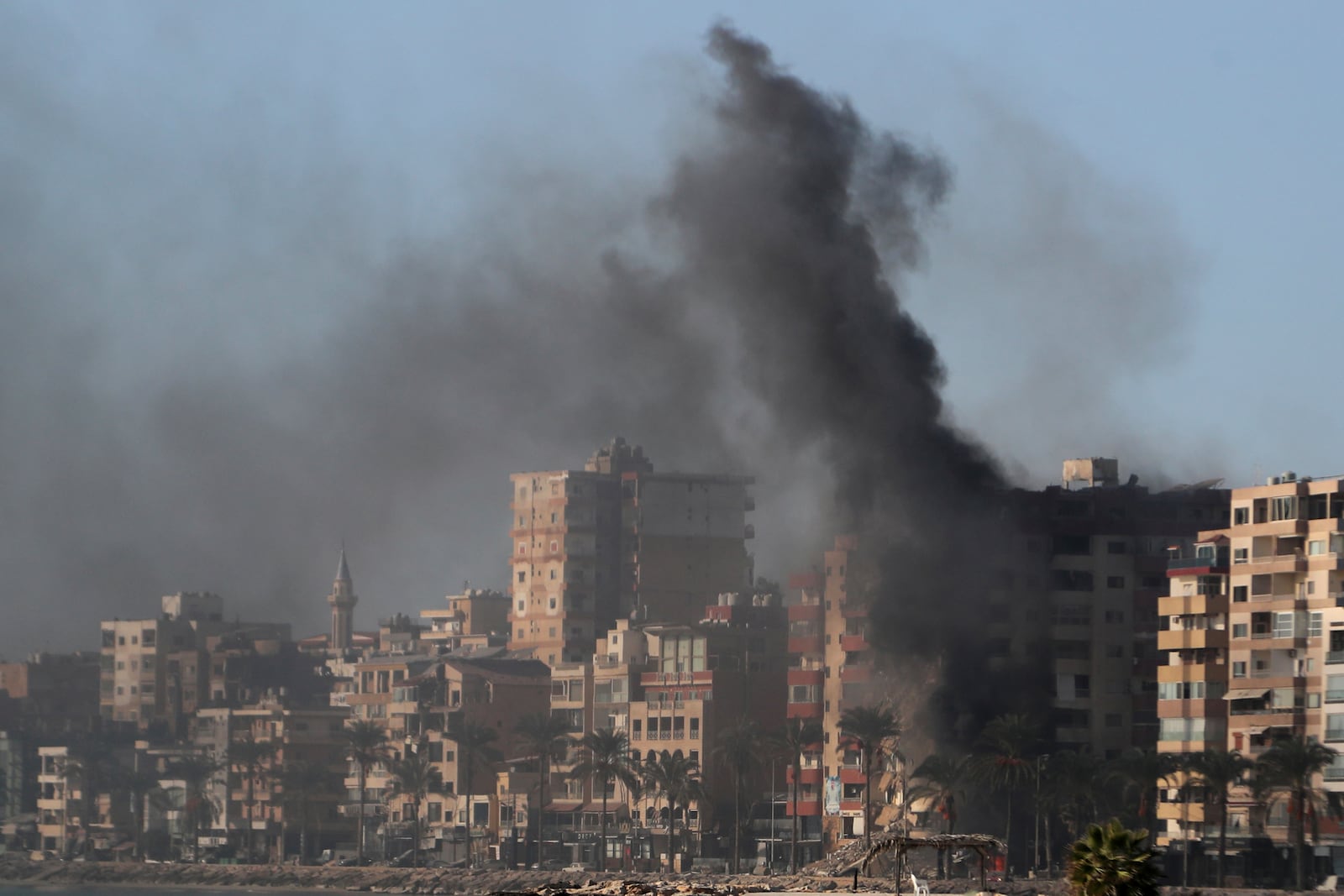 Smoke rises from a building hit in an Israeli airstrike in Tyre, southern Lebanon, Monday, Oct. 28, 2024. (AP Photo/Mohammad Zaatari)