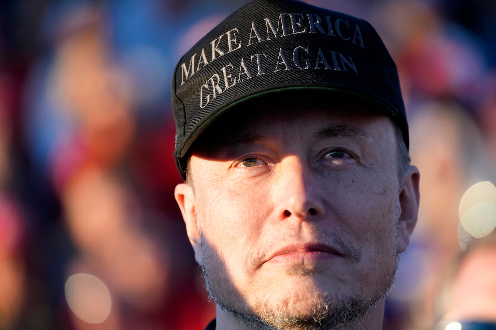 FILE - Tesla and SpaceX CEO Elon Musk listens as Republican presidential nominee former President Donald Trump speaks at a campaign event at the Butler Farm Show, Oct. 5, 2024, in Butler, Pa. (AP Photo/Alex Brandon, File)