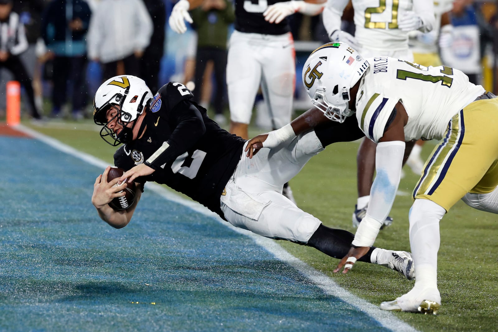 Vanderbilt quarterback Diego Pavia (2) dives into the end zone for a touchdown as he gets past Georgia Tech linebacker Tah'j Butler (15) during the second half of the Birmingham Bowl NCAA college football game, Friday, Dec. 27, 2024, in Birmingham, Ala. (AP Photo/Butch Dill)