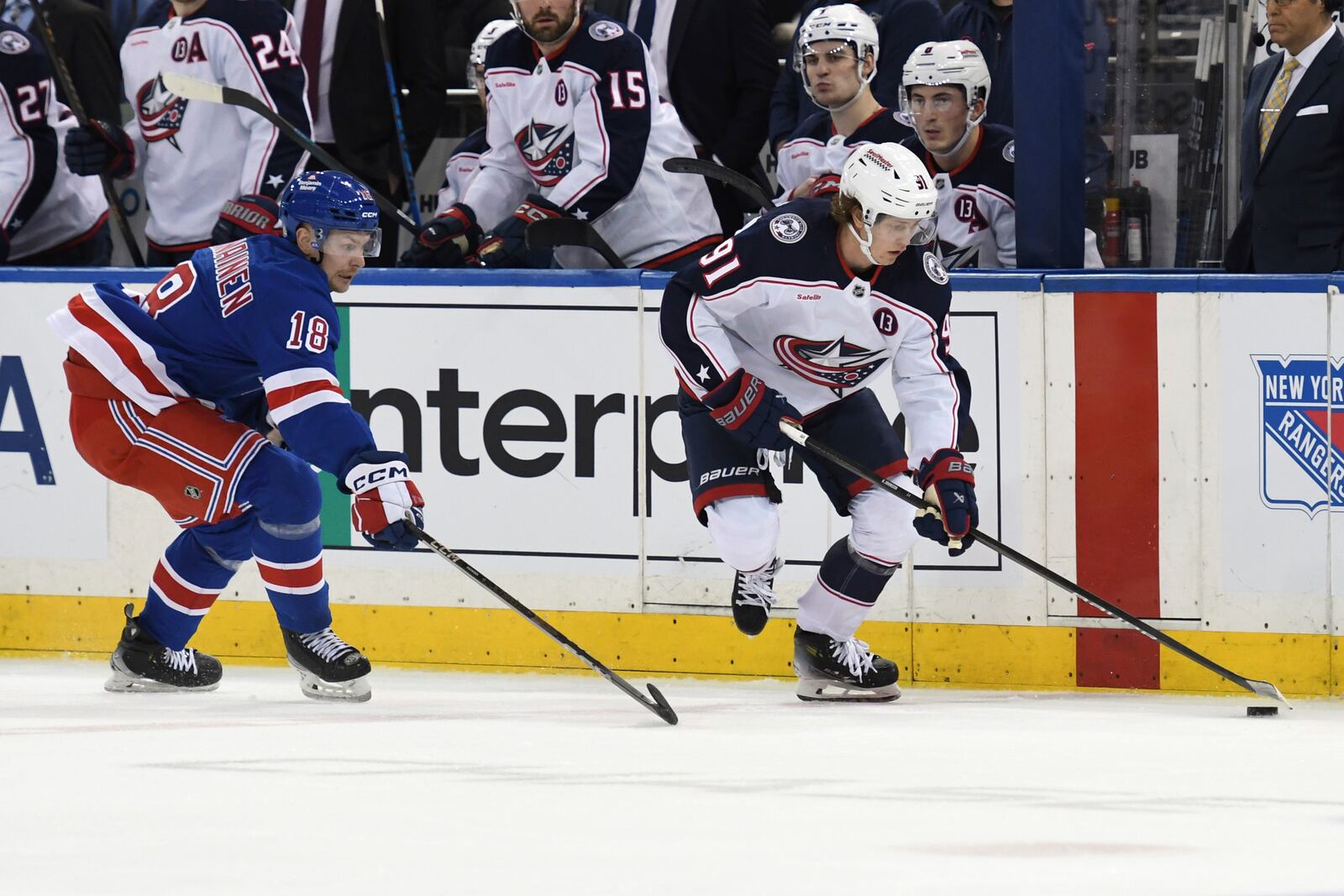 Columbus Blue Jackets' Kent Johnson, right, skates with the puck against New York Rangers' Urho Vaakanainen, left, during the second period of an NHL hockey game Saturday, Jan. 18, 2025, in New York. (AP Photo/Pamela Smith)