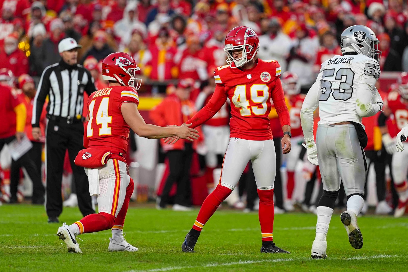 Kansas City Chiefs kicker Matthew Wright (49) celebrates with Matt Araiza (14) after a field goal against the Las Vegas Raiders during the second half of an NFL football game in Kansas City, Mo., Friday, Nov. 29, 2024. (AP Photo/Charlie Riedel)