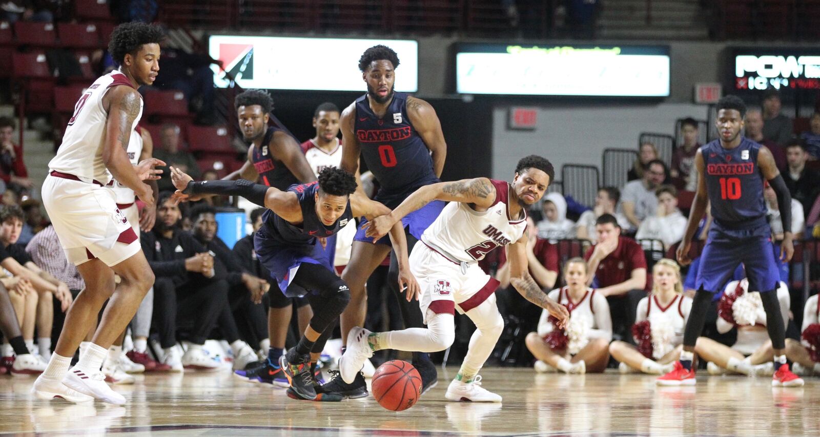 Dayton’s Darrell Davis and Massachusetts guard Luwane Pipkins chase a loose ball on Saturday, Feb. 3, 2018, at the Mullins Center in Amherst, Mass.