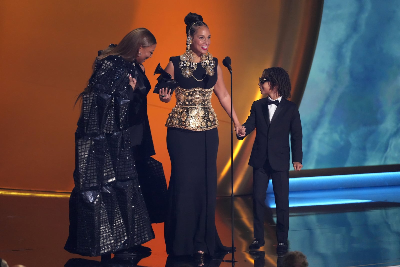 Queen Latifah, left, presents the Dr. Dre Global Impact Award to Alicia Keys during the 67th annual Grammy Awards on Sunday, Feb. 2, 2025, in Los Angeles. Genesis Ali Dean looks on from right.(AP Photo/Chris Pizzello)