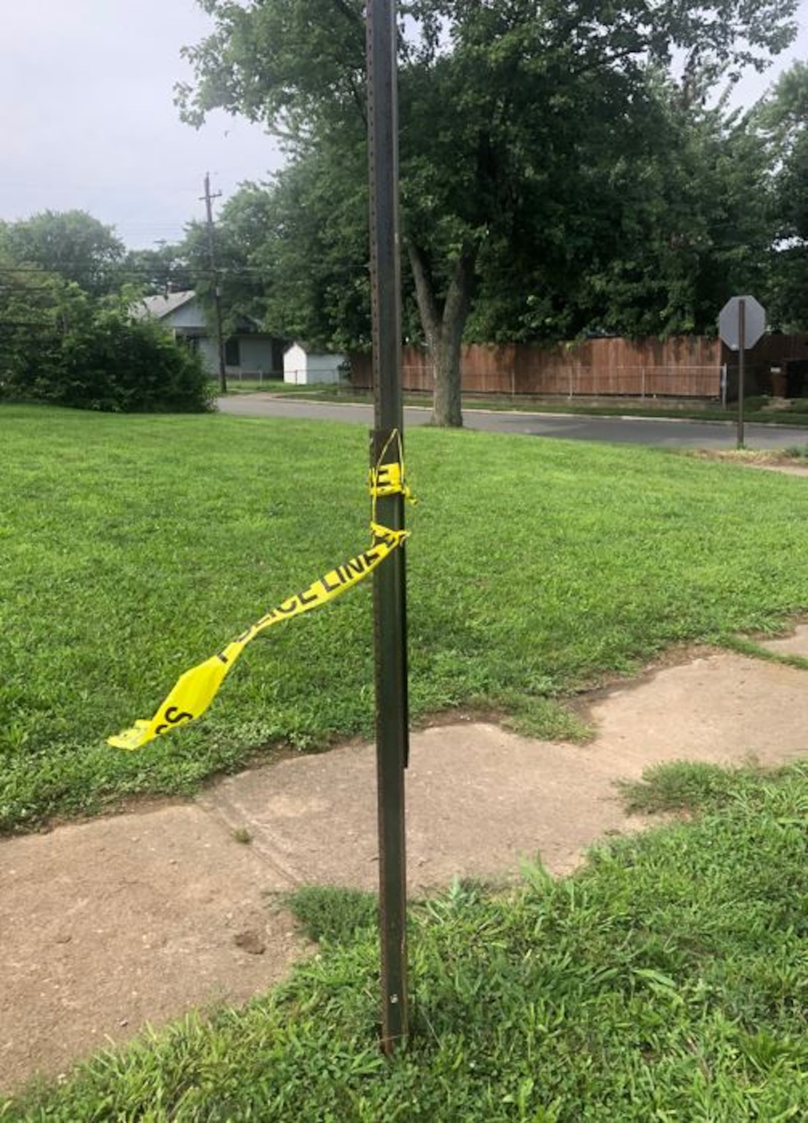 Police tape was wrapped around a bus stop sign this morning near Grand Avenue and Wilson Street. RICK McCRABB/STAFF