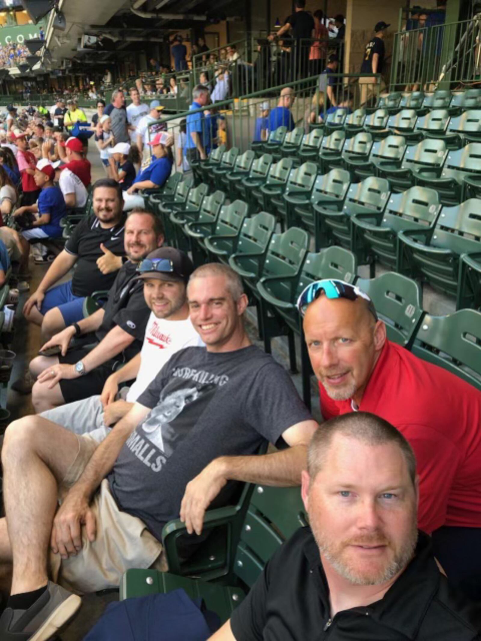 Brent Parke, center in grey shirt, and friends visit Wrigley Field in 2019.