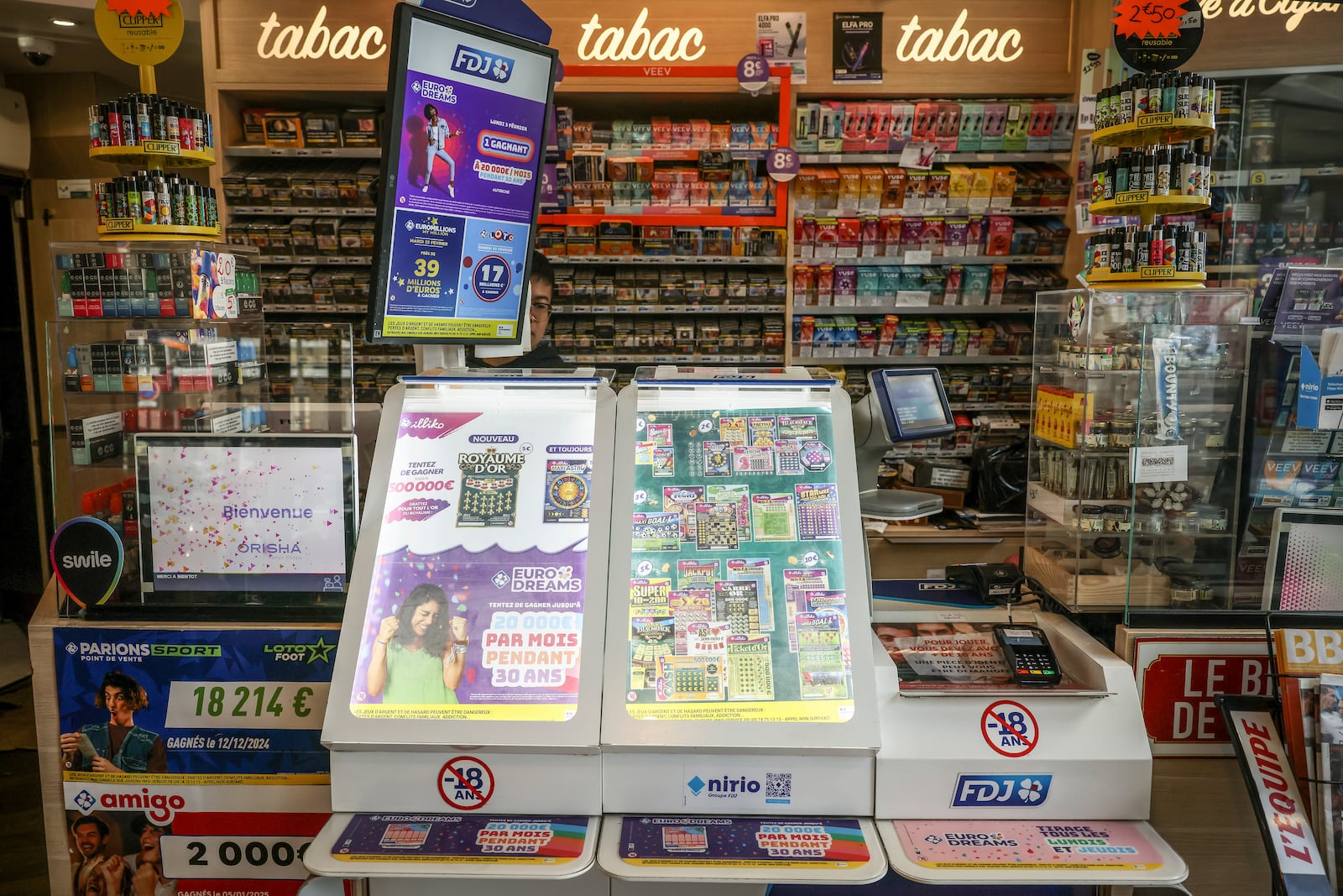 Lottery tickets are on display in a tobacco shop, in Paris, Saturday, Feb. 22, 2025. (AP Photo/Thomas Padilla)