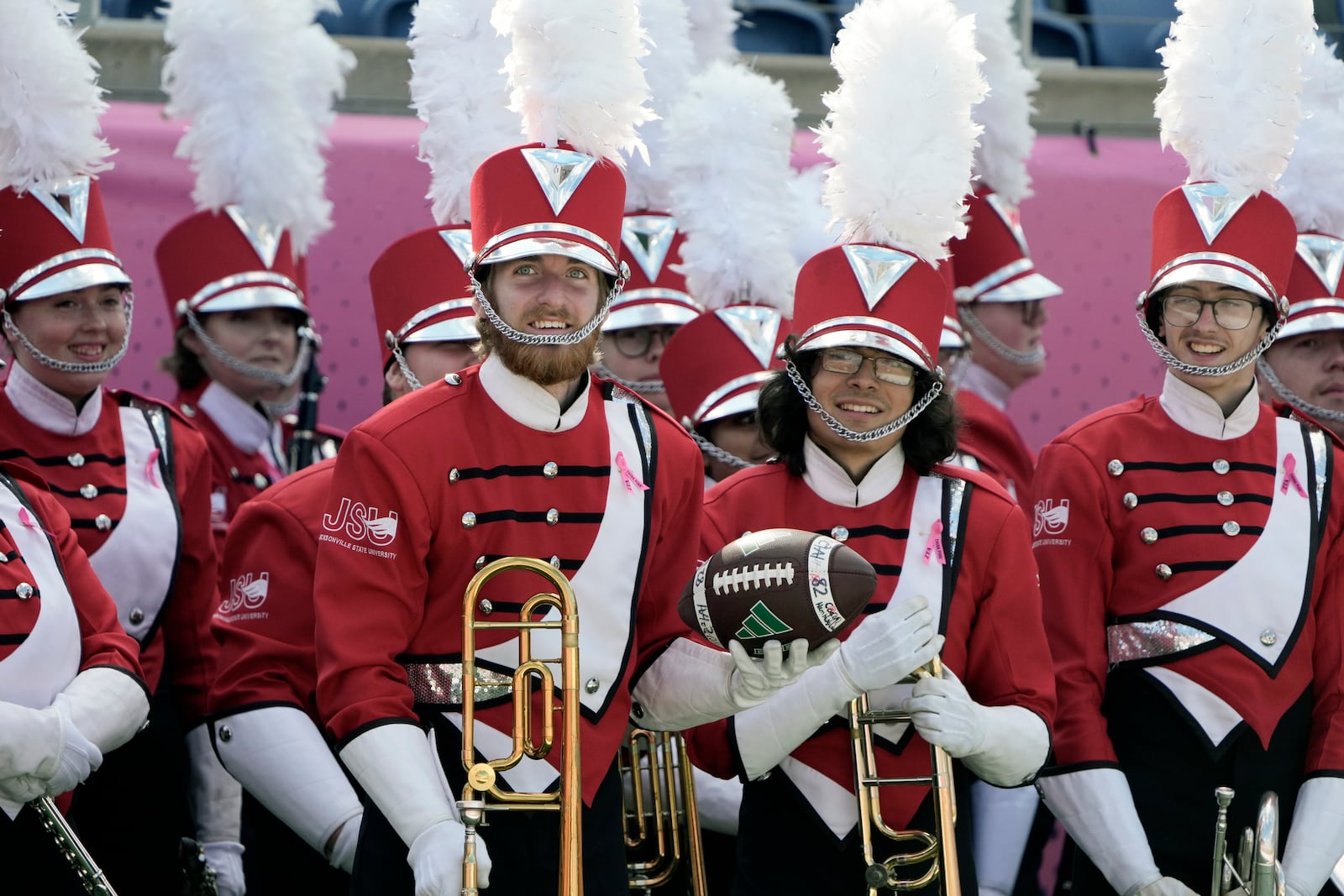 A member of the Jacksonville State band catches a football that went past the end zone near the end of the first half of the Cure Bowl NCAA college football game between Ohio and Jacksonville State , Friday, Dec. 20, 2024, in Orlando, Fla. (AP Photo/John Raoux)