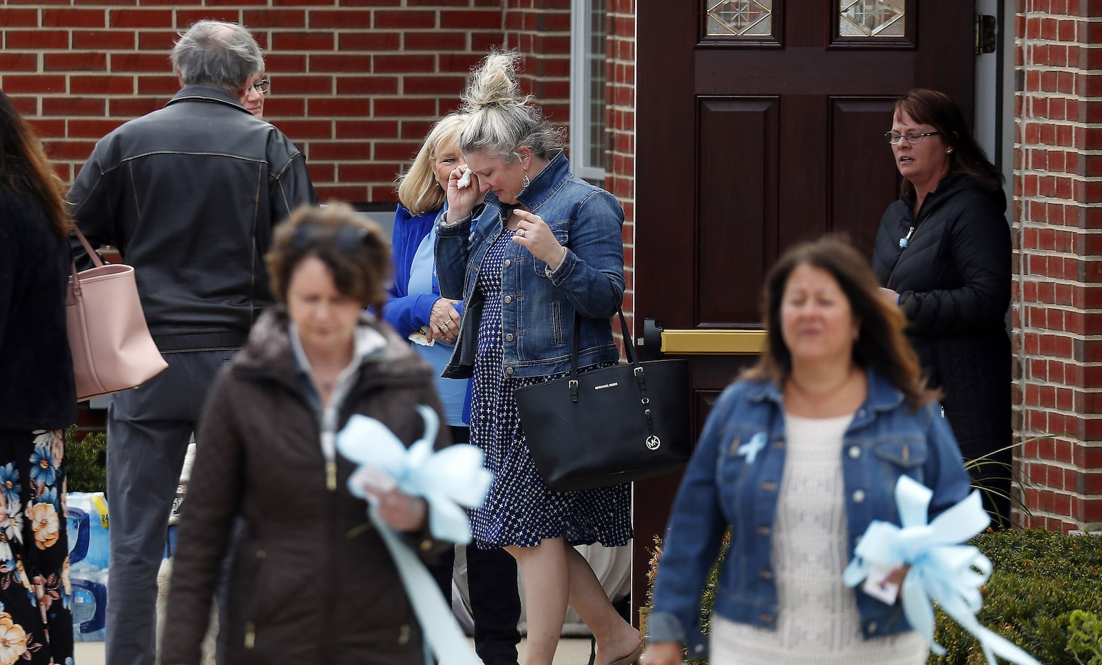 Mourners wipe away tears May 3, 2019, as they leave visitation services for Andrew "AJ" Freund Jr., 5, at Davenport Funeral Home in Crystal Lake, Ill. AJ’S parents, Andrew Freund Sr., 60, and JoAnn Cunningham, 36, face multiple charges, including five counts of first-degree murder, in his April 15 death. The boy, who was reported missing from the family's home April 18, 2019, was found wrapped in plastic and buried in a shallow grave six days later.