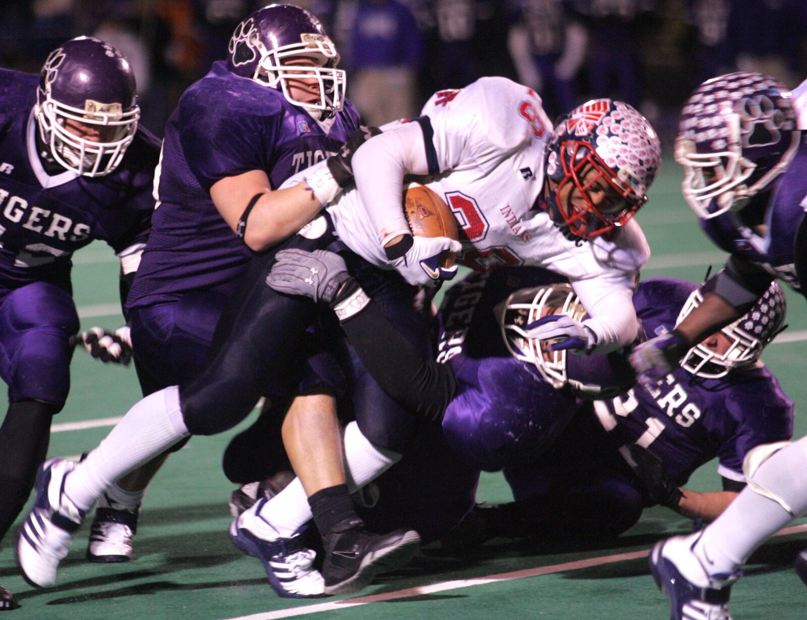 1 Dec 06 Photo by Ron Alvey. Brandon Saine, a Piqua runner, drags members of the Pickerington Central Tigers defense as he gains second half yards. Piqua won the Division II championship game by a score of 26-7. Saine score three touchdowns in the game.