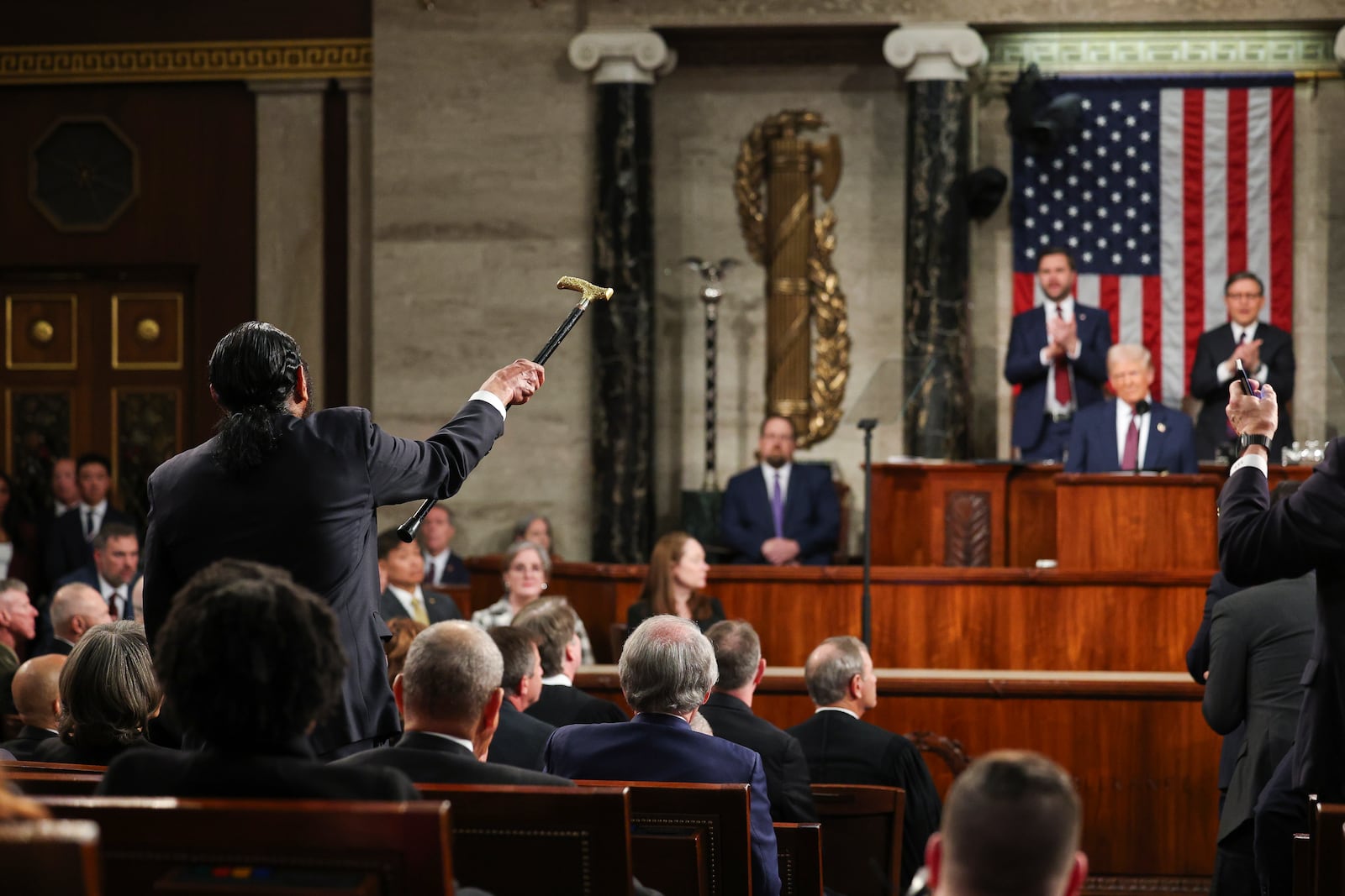 Rep. Al Green, D-Texas, left, shouts as President Donald Trump addresses a joint session of Congress at the Capitol in Washington, Tuesday, March 4, 2025. (Win McNamee/Pool Photo via AP)