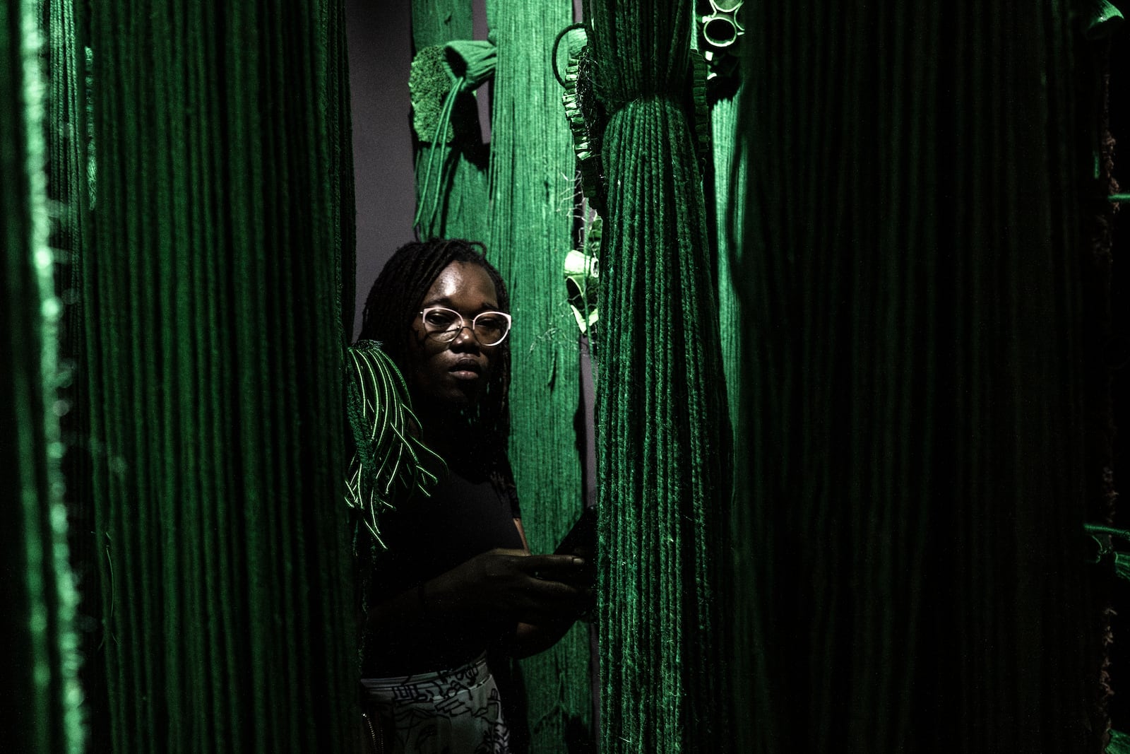 A visitor explores the international exhibit at the Dakar Biennale of Contemporary African Art in Dakar, Senegal, Friday, Nov. 8, 2024. (AP Photo/Annika Hammerschlag)