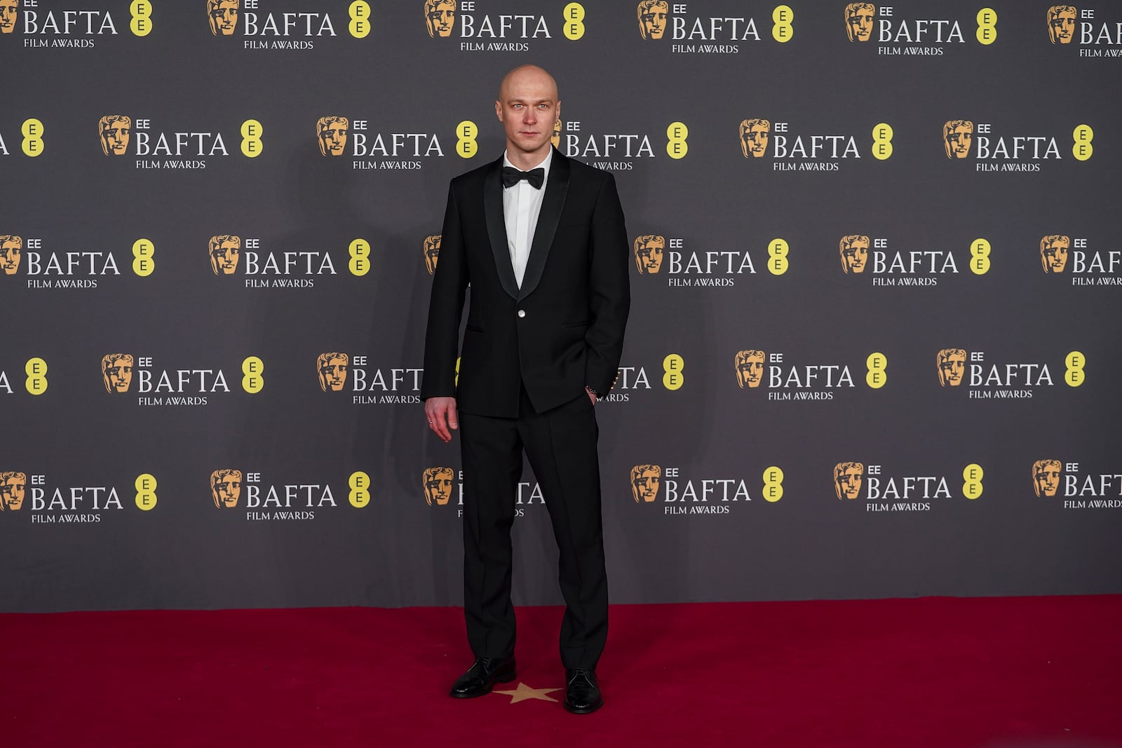 Yura Borisov poses for photographers upon arrival at the 78th British Academy Film Awards, BAFTA's, in London, Sunday, Feb. 16, 2025. (Photo by Alberto Pezzali/Invision/AP)