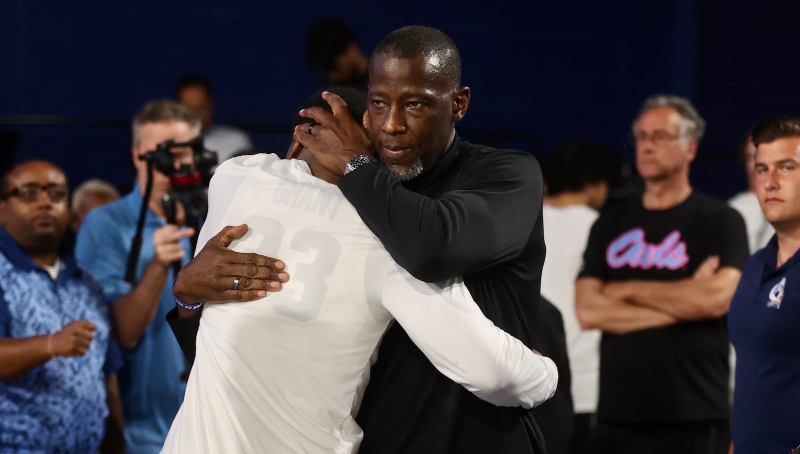 Dayton's Anthony Grant hugs his son Makai Grant after a victory against Florida Atlantic in the first round of the NIT on Wednesday, March 19, 2025, at Baldwin Arena in Boca Raton, Fla. David Jablonski/Staff