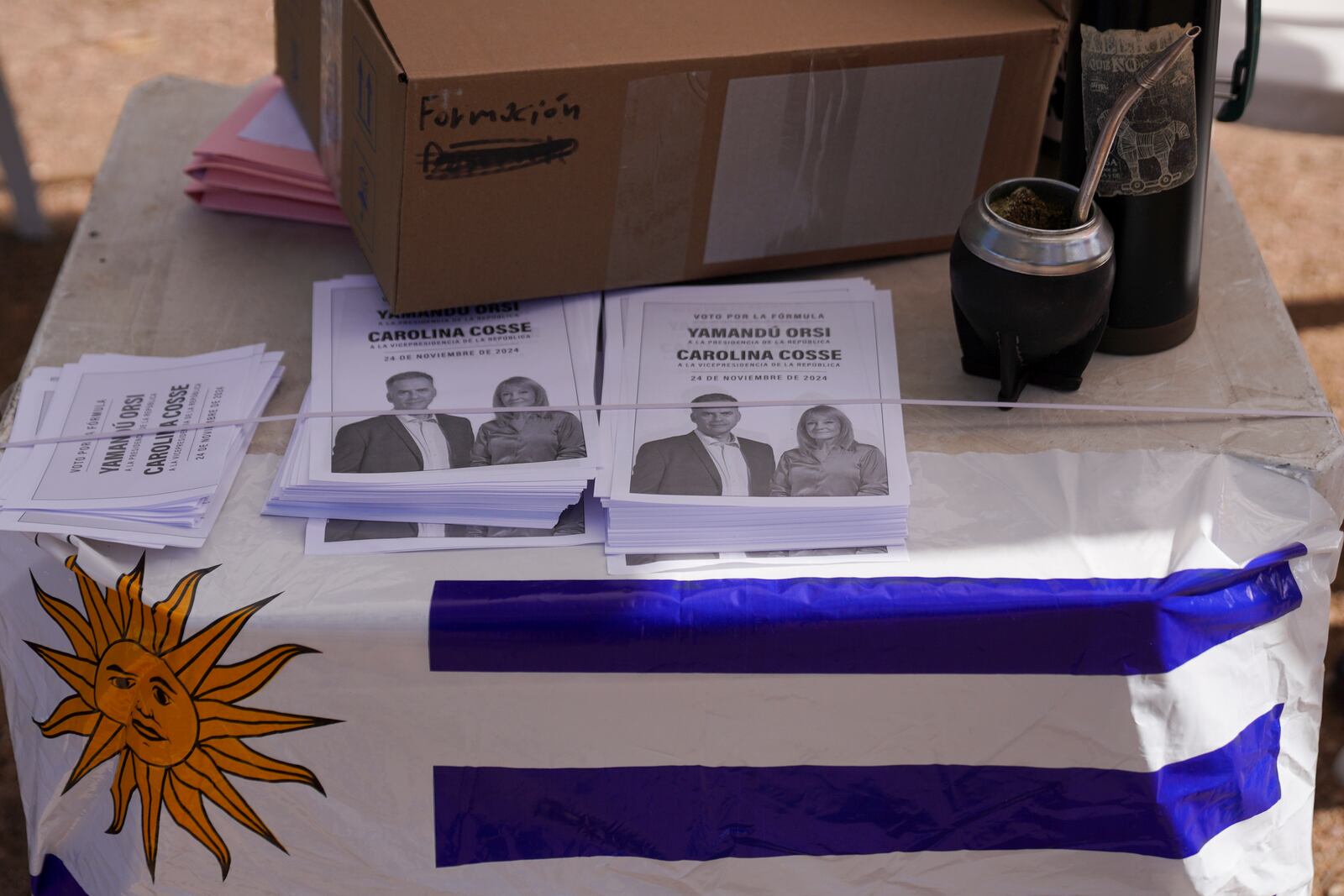 Ballots of Frente Amplio presidential candidate Yamandu Orsi with running mate Carolina Cosse sit on a table outside a polling station in the presidential run-off election in Canelones, Uruguay, Sunday, Nov. 24, 2024. (AP Photo/Matilde Campodonico)