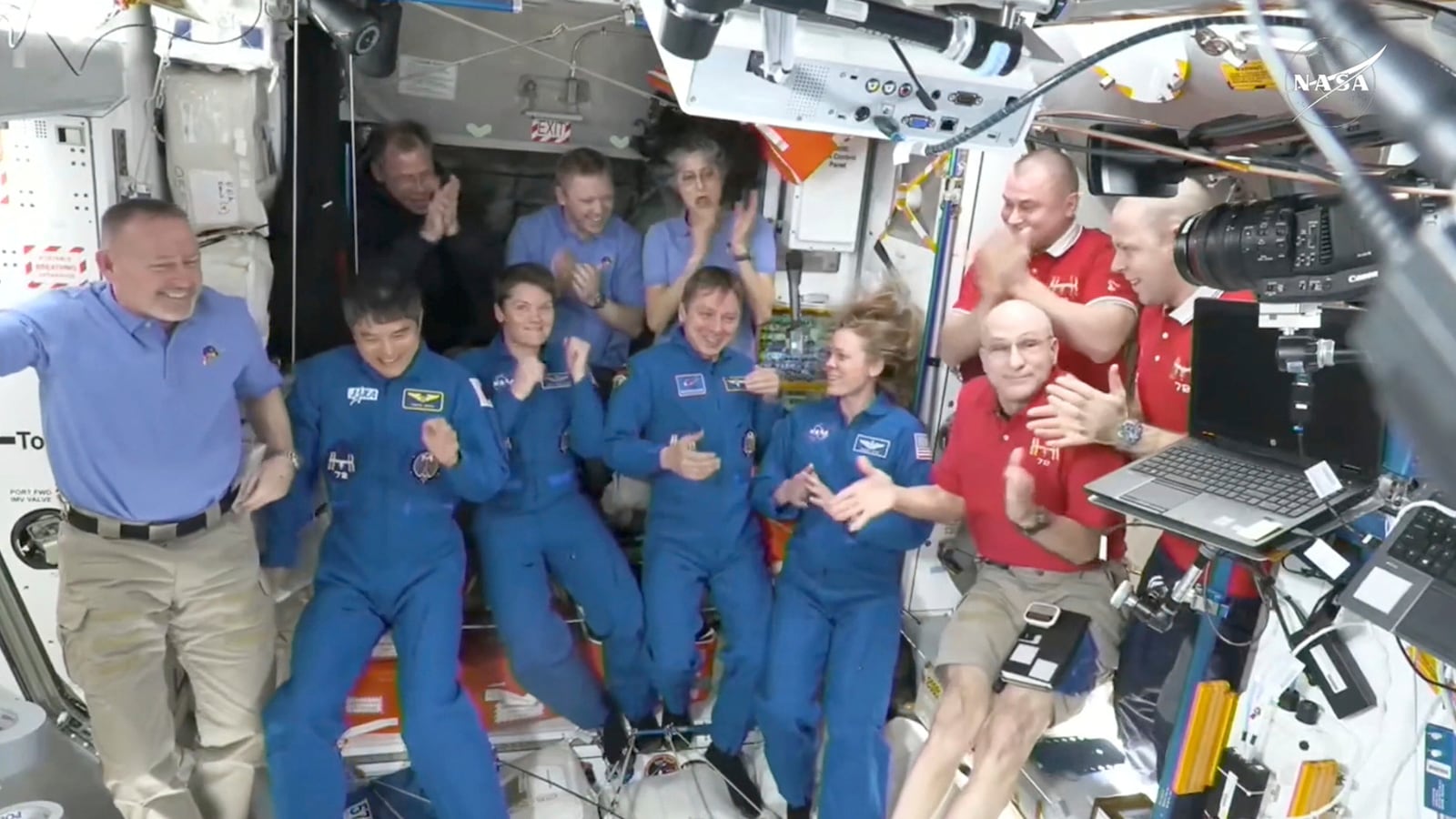 This image made from video by NASA shows astronauts greeting each other after the SpaceX capsule docked with the International Space Station, Sunday, March 16, 2025. Top row from left: Nick Hague, Alexander Gorbunov, Suni Williams, Alexei Ovchinin and Ivan Vagner. Bottom row from left: Butch Wilmore, Takuya Onishi, Anne McClain, Kirill Peskov, Nichole Ayers, Don Pettit. (NASA via AP)