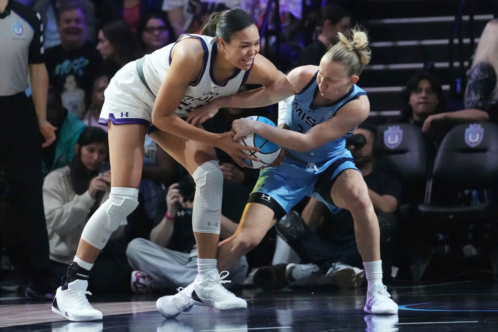 Mist's Courtney Vandersloot, right, and Lunar Owls' Napheesa Collier, left, go after the ball during the first half of the inaugural Unrivaled 3-on-3 basketball game, Friday, Jan. 17, 2025, in Medley, Fla. (AP Photo/Marta Lavandier)