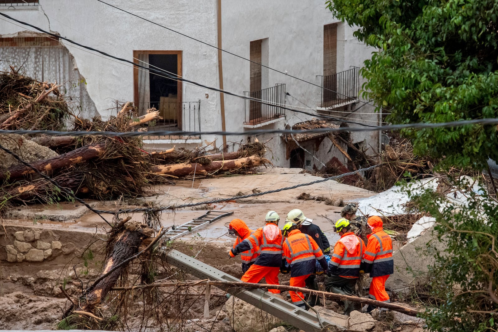 Members of emergency services carry the body of a person trapped after floods in Letur, Albacete, Tuesday, Oct. 29, 2024. (Víctor Fernández/Europa Press via AP)