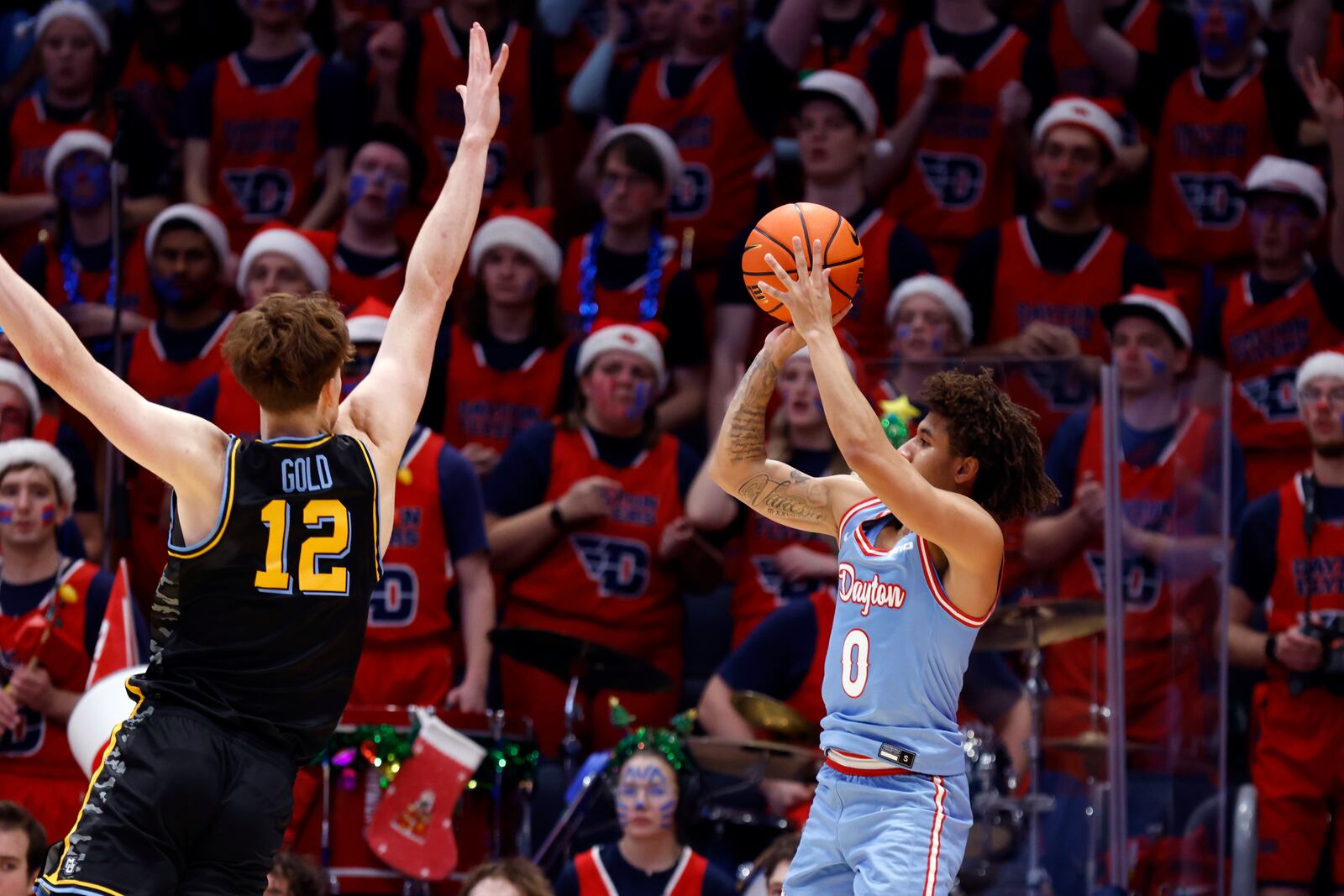 Dayton guard Javon Bennett (0) looks to shoot in front of Marquette forward Ben Gold (12) during the first half of an NCAA college basketball game in Dayton, Ohio, Saturday, Dec. 14, 2024. (AP Photo/Paul Vernon)