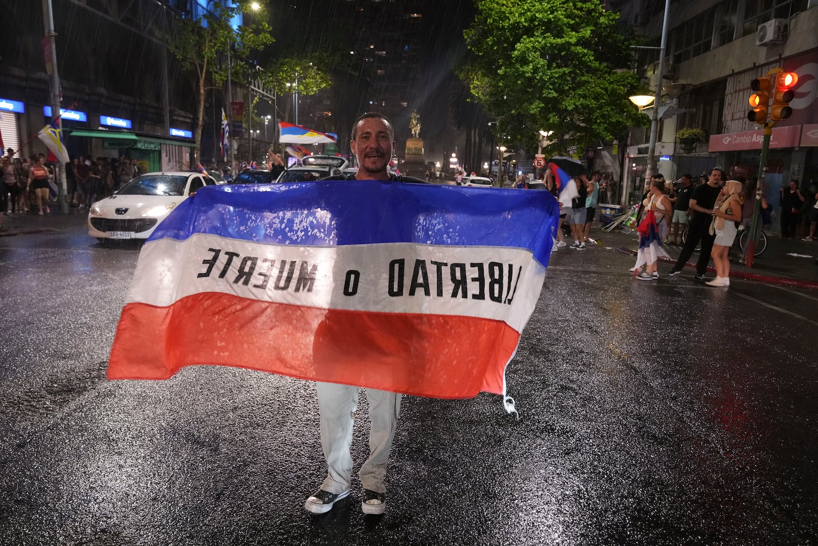 Supporters of the Broad Front (Frente Amplio) celebrate the victory of candidate Yamandú Orsi in the presidential run-off election in Montevideo, Uruguay, Sunday, Nov. 24, 2024. (AP Photo/Matilde Campodonico)