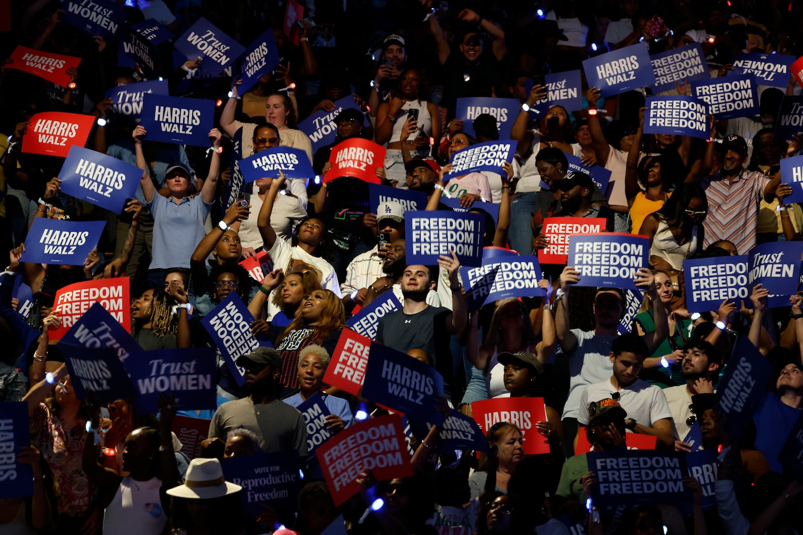 Attendees hold signs at a campaign rally for Democratic presidential nominee Vice President Kamala Harris, Friday, Oct. 25, 2024, in Houston. (AP Photo/Annie Mulligan)