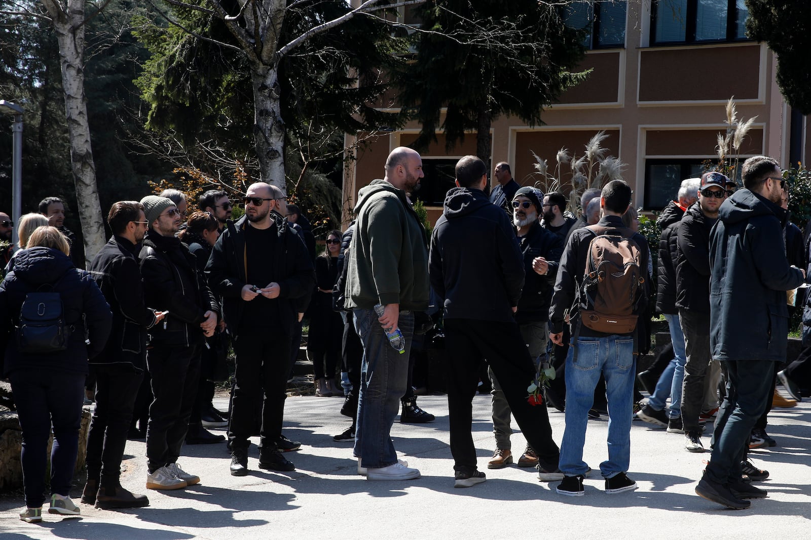 Relatives and friends gather at a chapel for the funeral of Andrej Gjorgieski, one of the lead singers of Macedonian band DNK, a victim of the March 16 nightclub fire in the town of Kocani, at a cemetery in Skopje, North Macedonia, Thursday, March 20, 2025. (AP Photo/Boris Grdanoski)