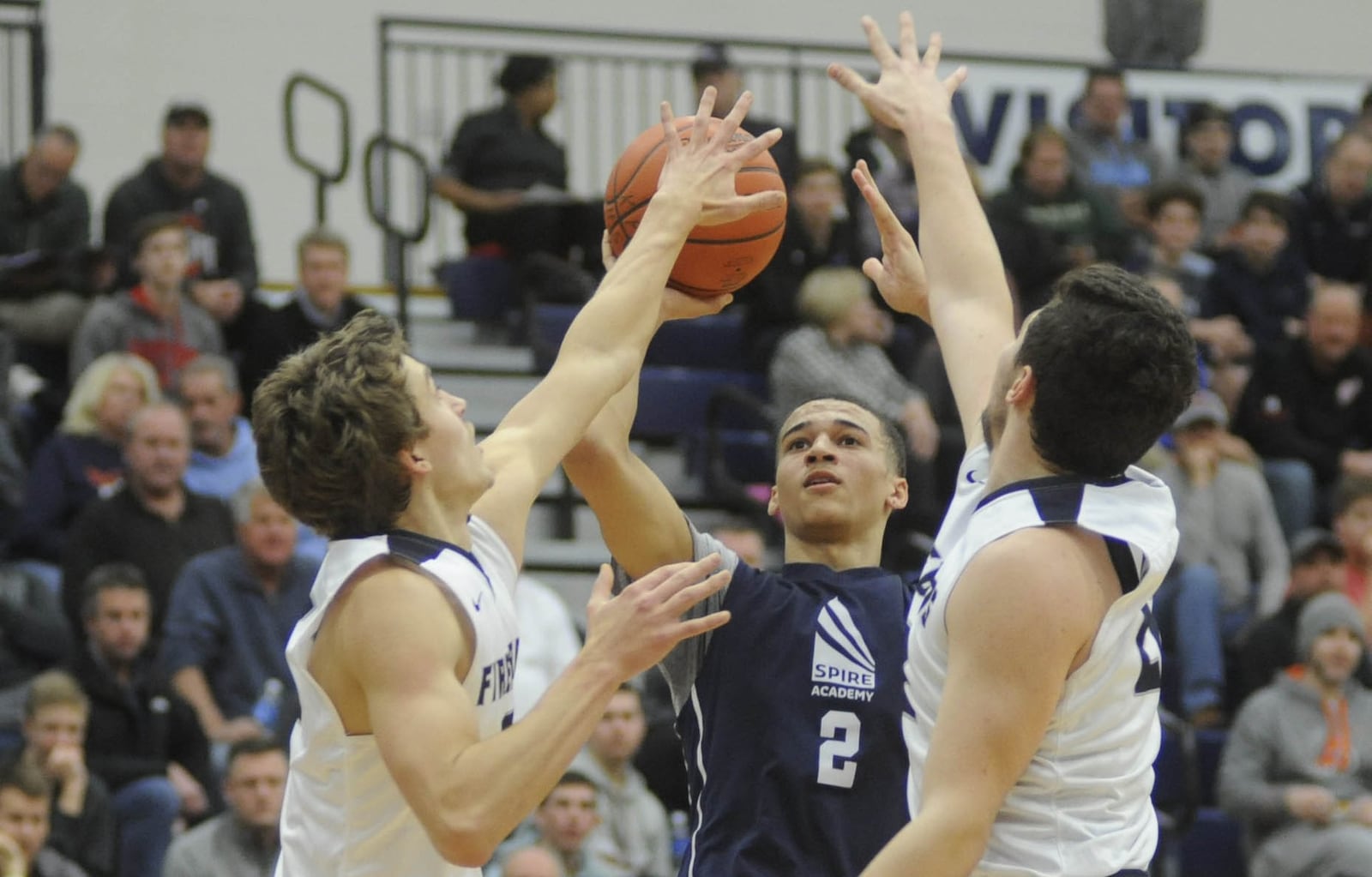 Caleb McConnell of Spire Academy fires over Fairmont defenders. Fairmont played Spire in the Premier Health Flyin’ to the Hoop opener at Trent Arena on Friday, Jan. 12, 2018. MARC PENDLETON / STAFF